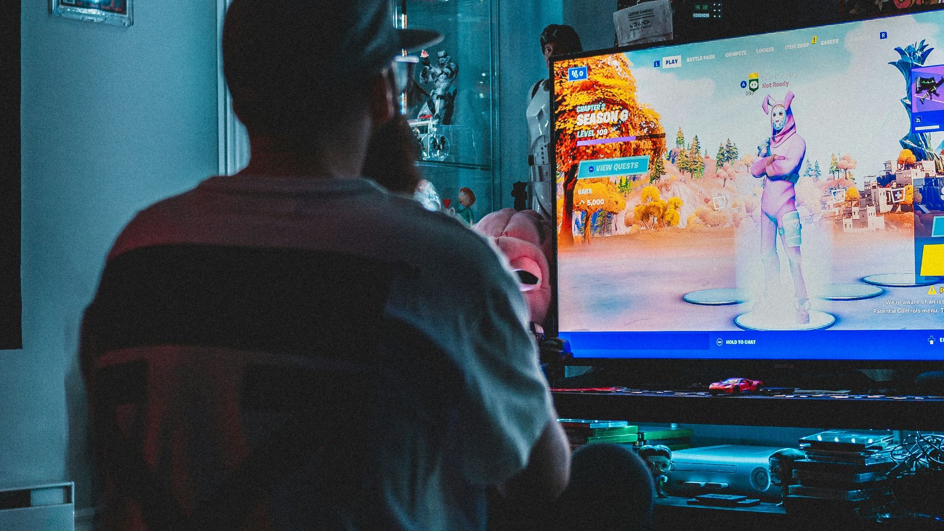 man in red shirt watching tv