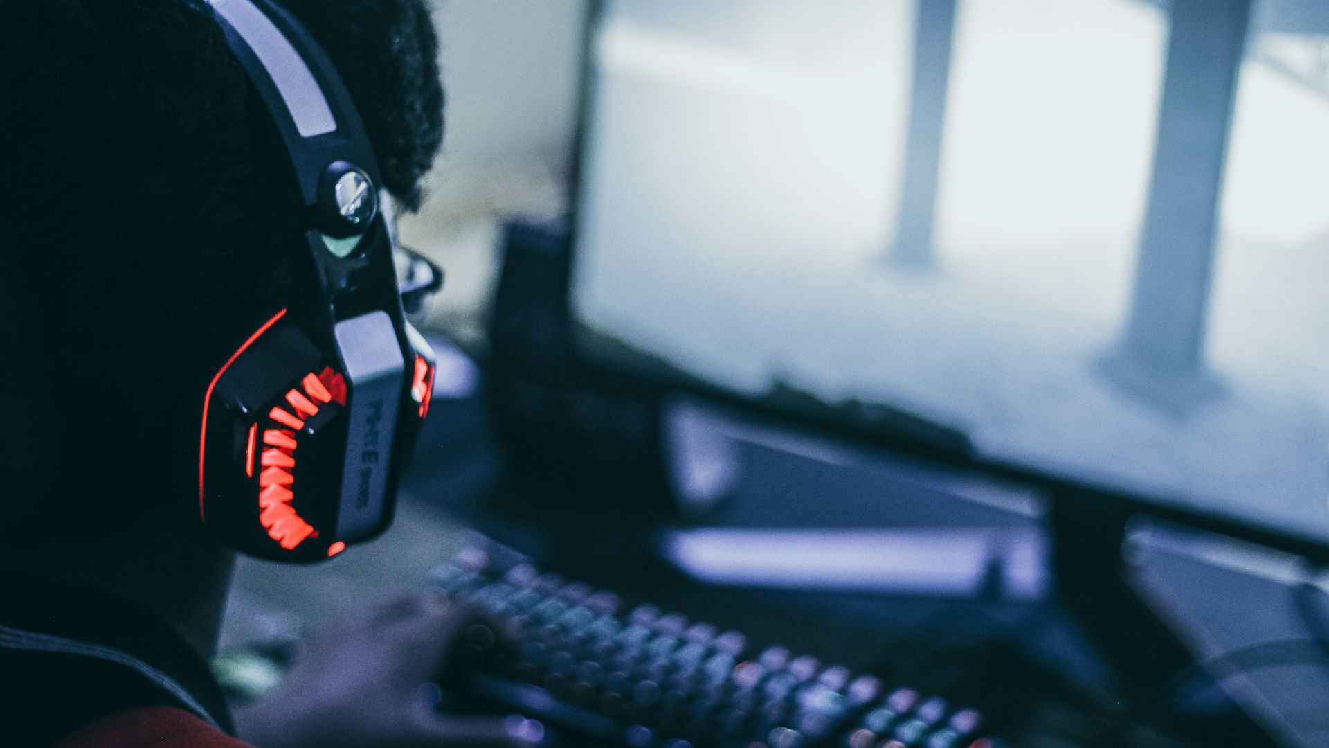 person wearing orange and black headphones
