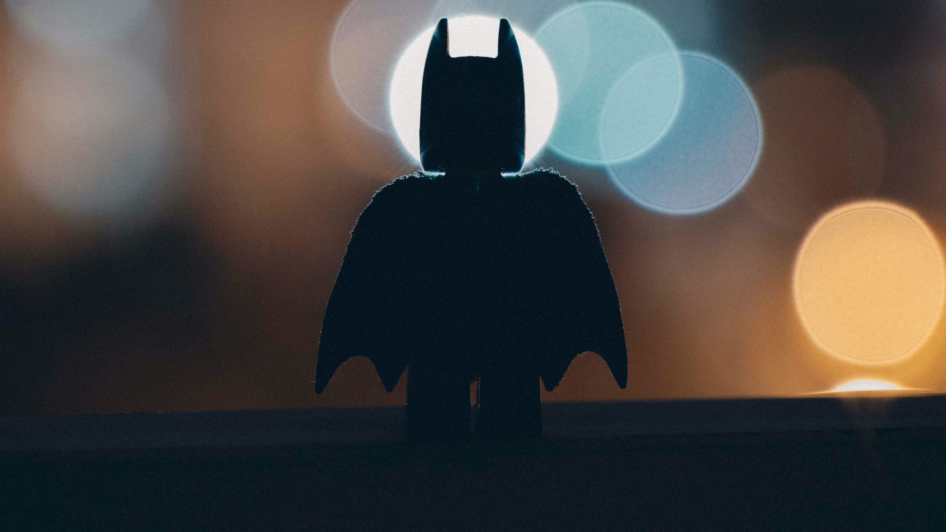 silhouette of person standing on the road during night time