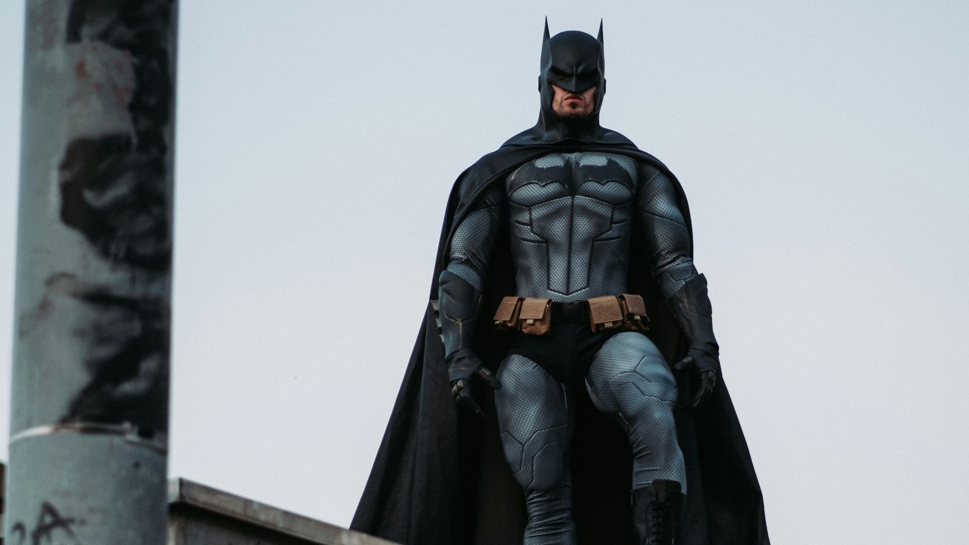 man in black jacket and pants standing on roof