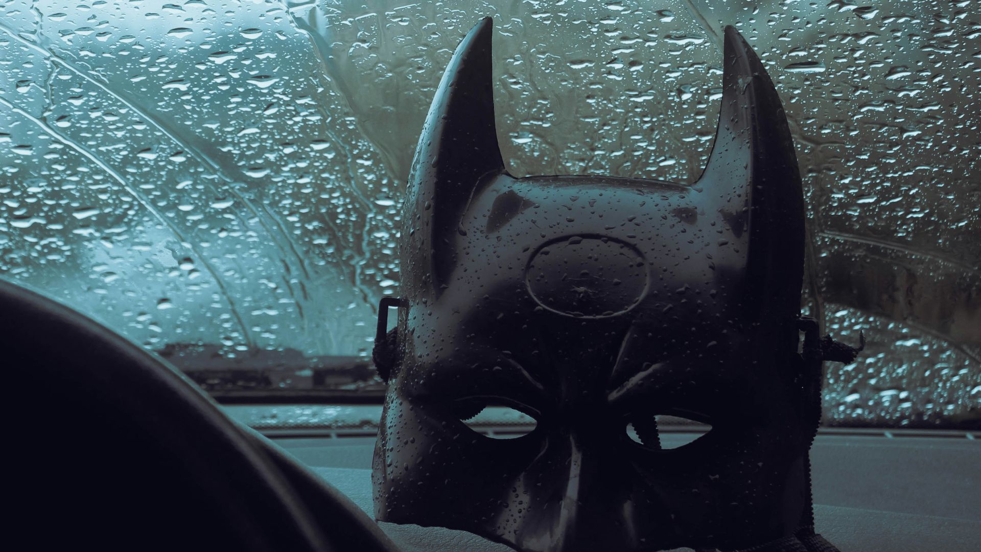 a batman mask sitting on top of a dashboard