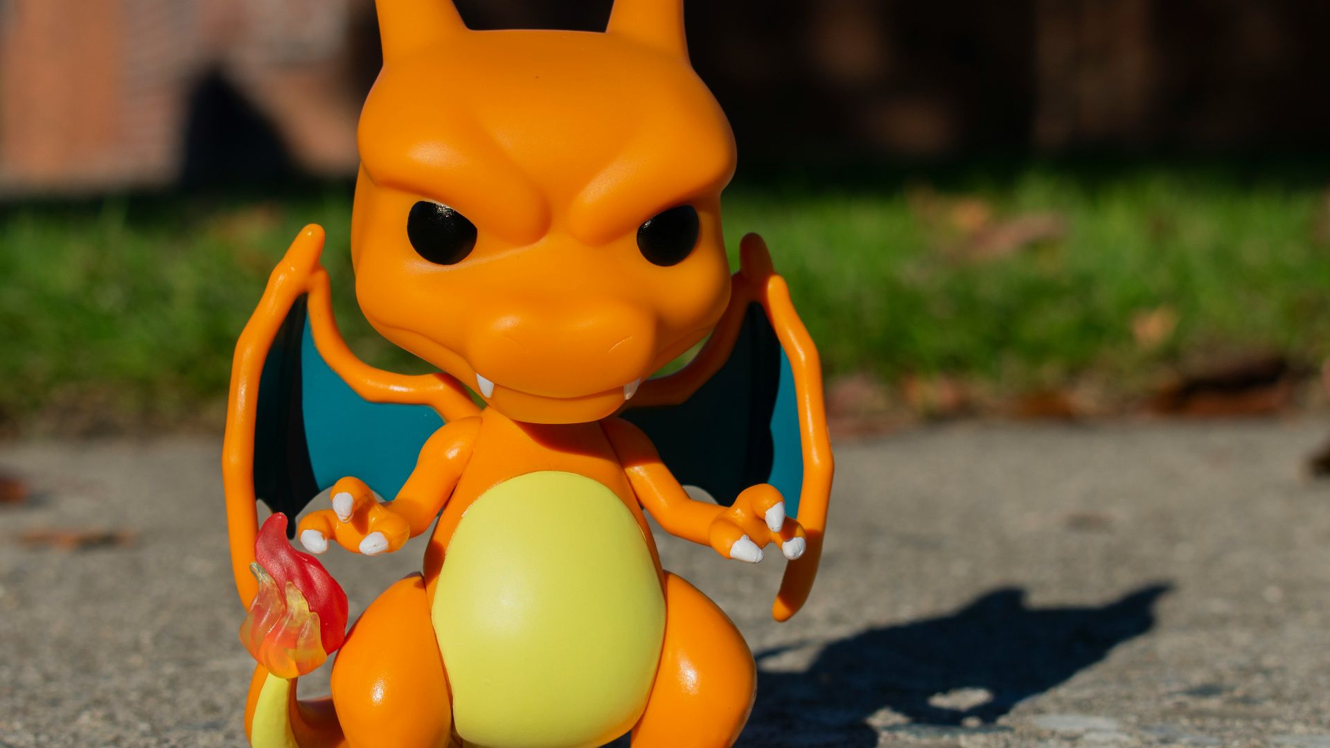 an orange toy sitting on top of a cement ground
