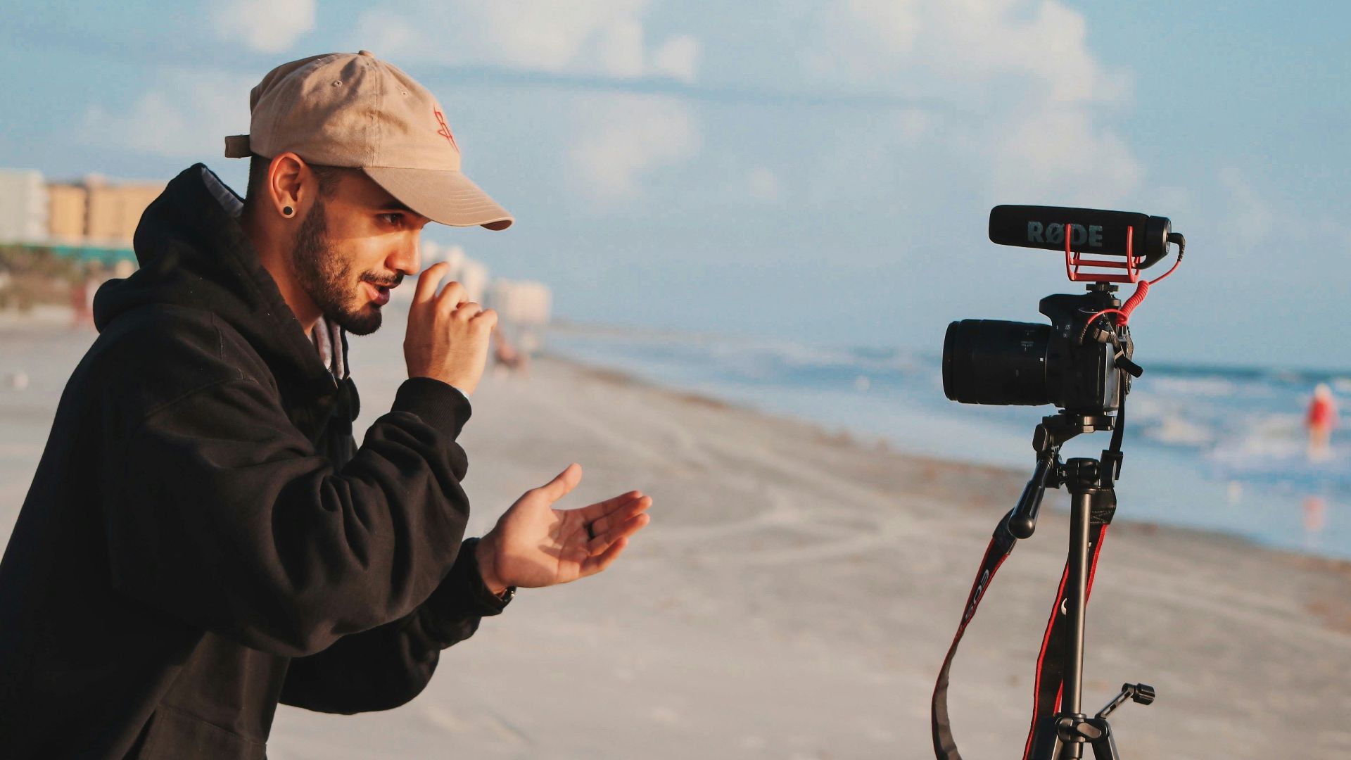 man in black jacket holding camera during daytime