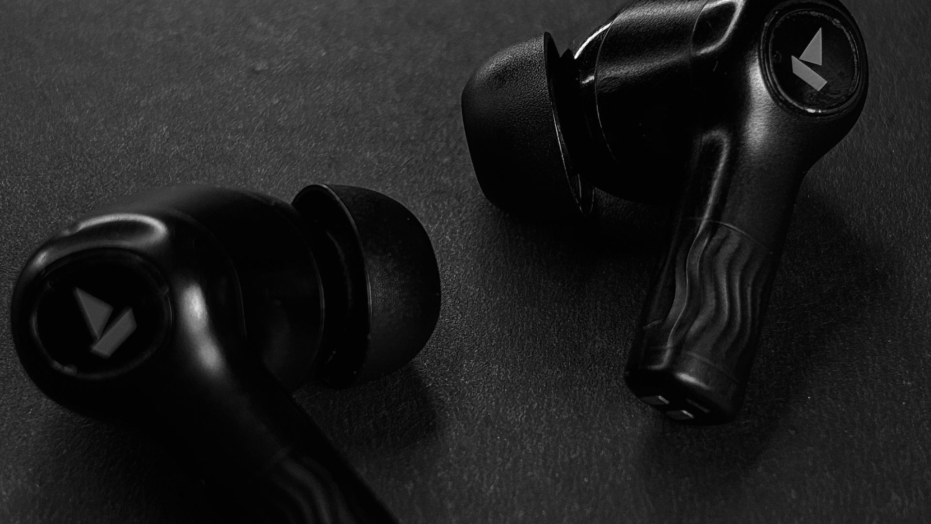 A pair of black earphones sitting on top of a table
