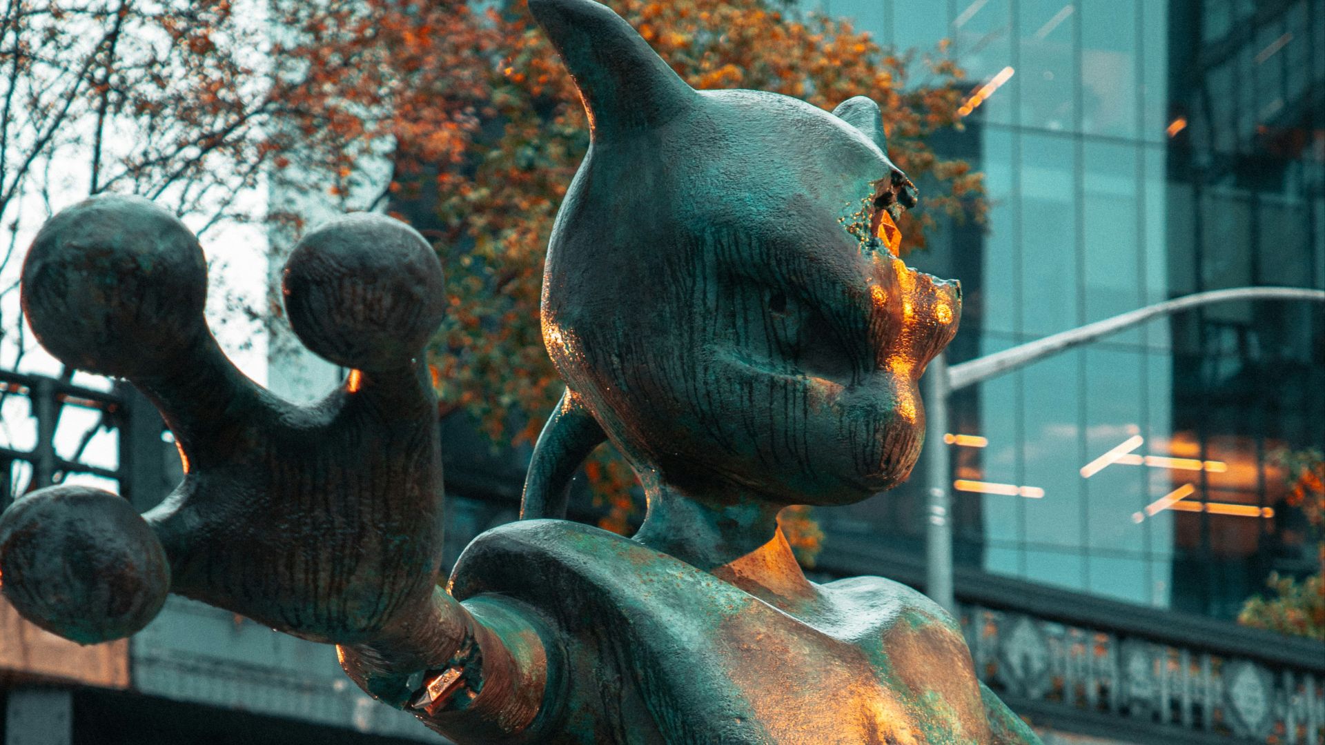 a statue of a cat on a horse on a city street