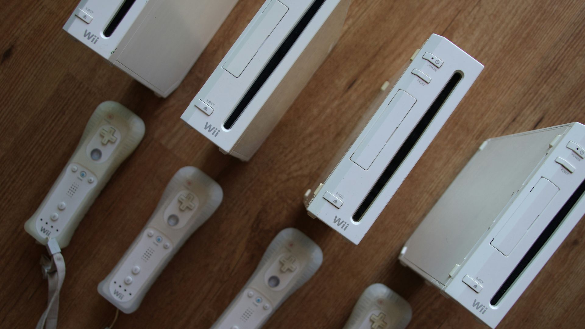 a group of video game controllers sitting on top of a wooden table