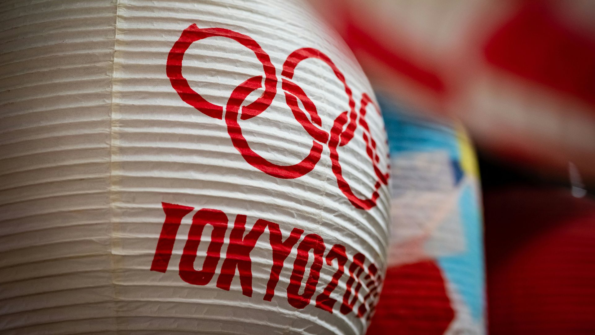 a close up of a paper lantern with the olympic logo on it