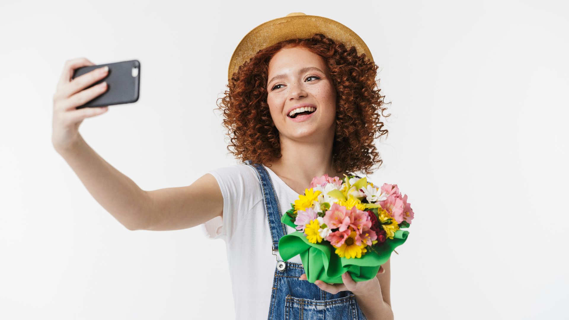 a woman taking a selfie with a flower bouquet
