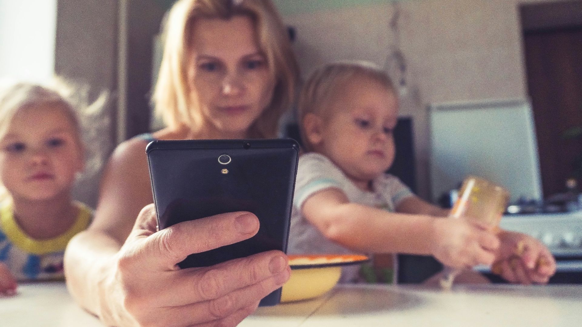 woman in white shirt holding black ipad