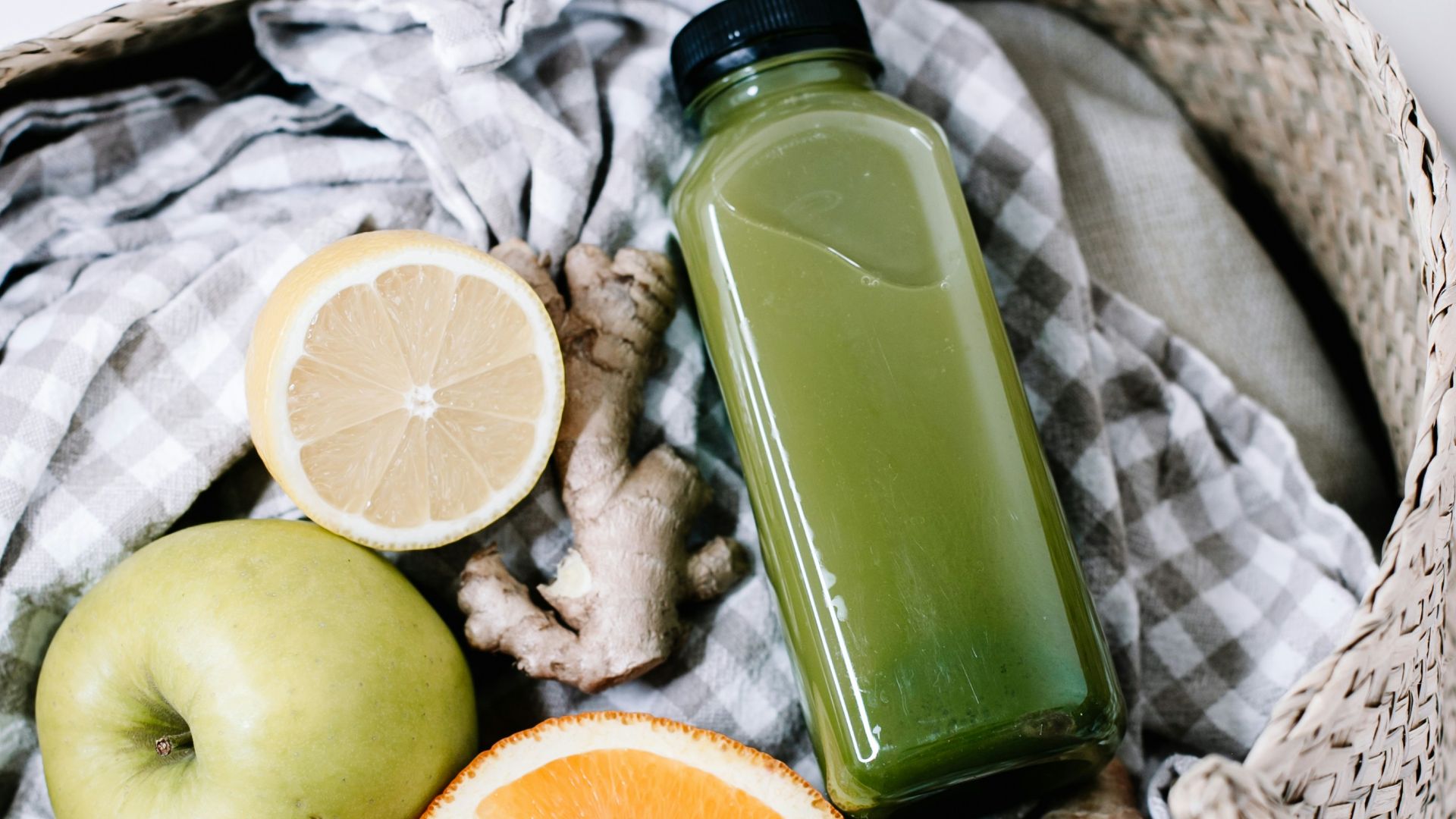 green disposable lighter beside orange fruit on brown woven basket