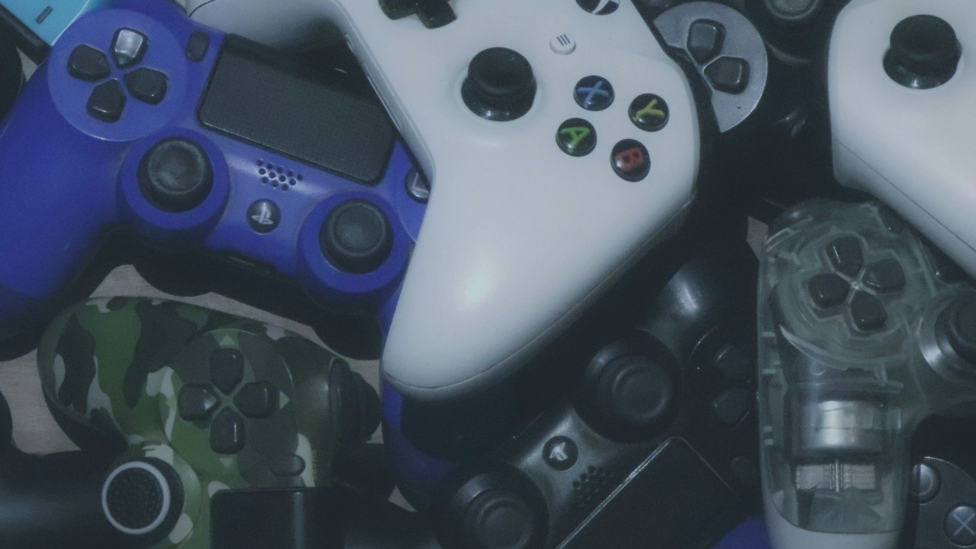 assorted-colored Xbox and Sony Playstaion game controller lot