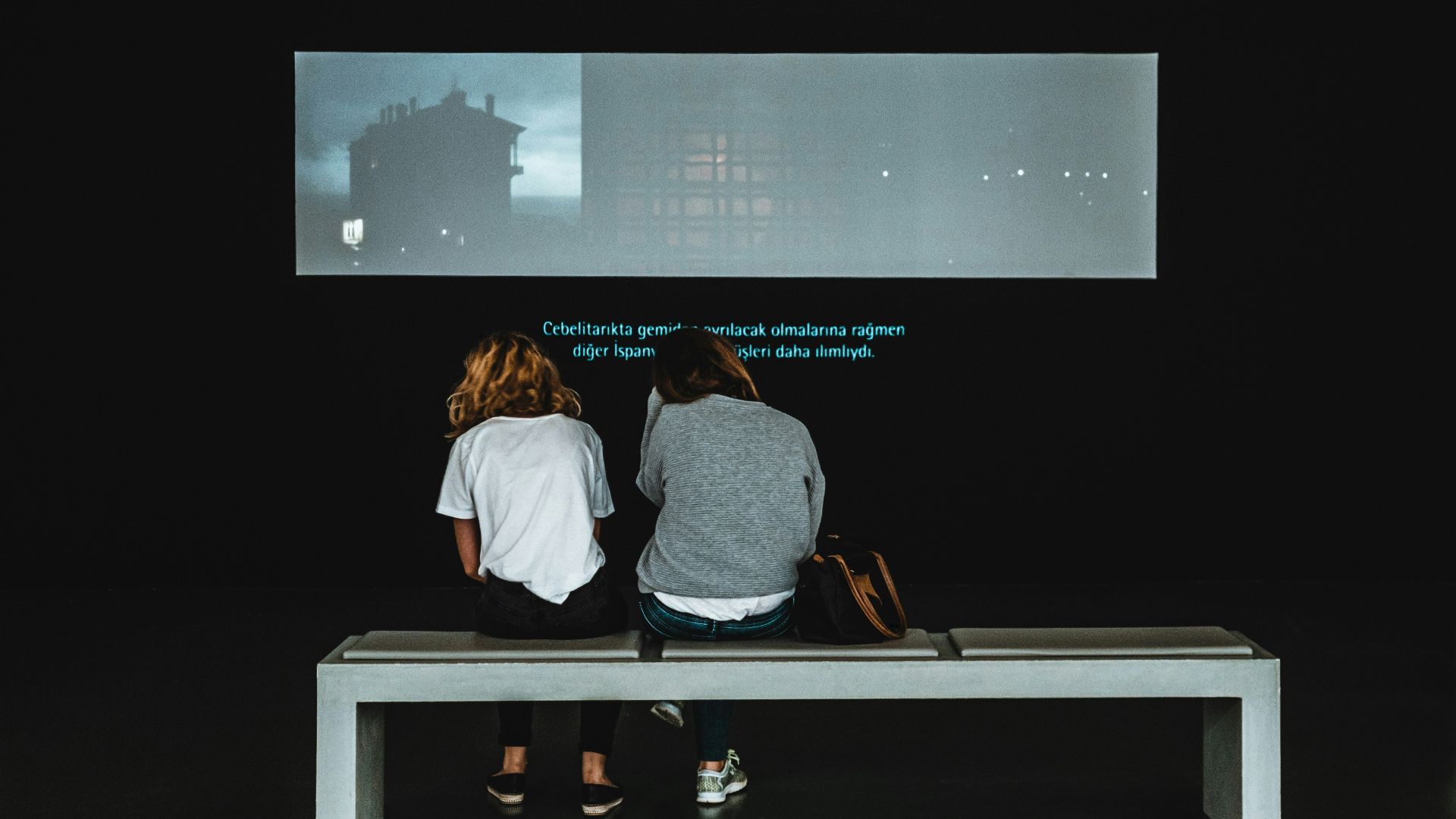 two women sitting on table