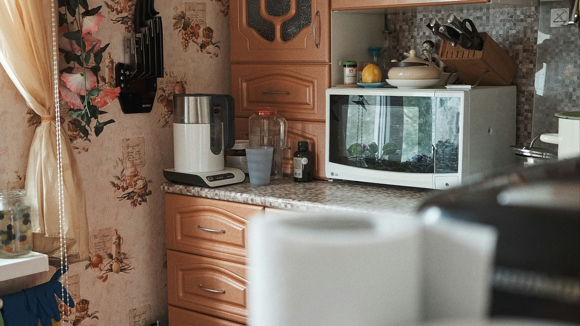 white microwave oven on brown wooden cabinet