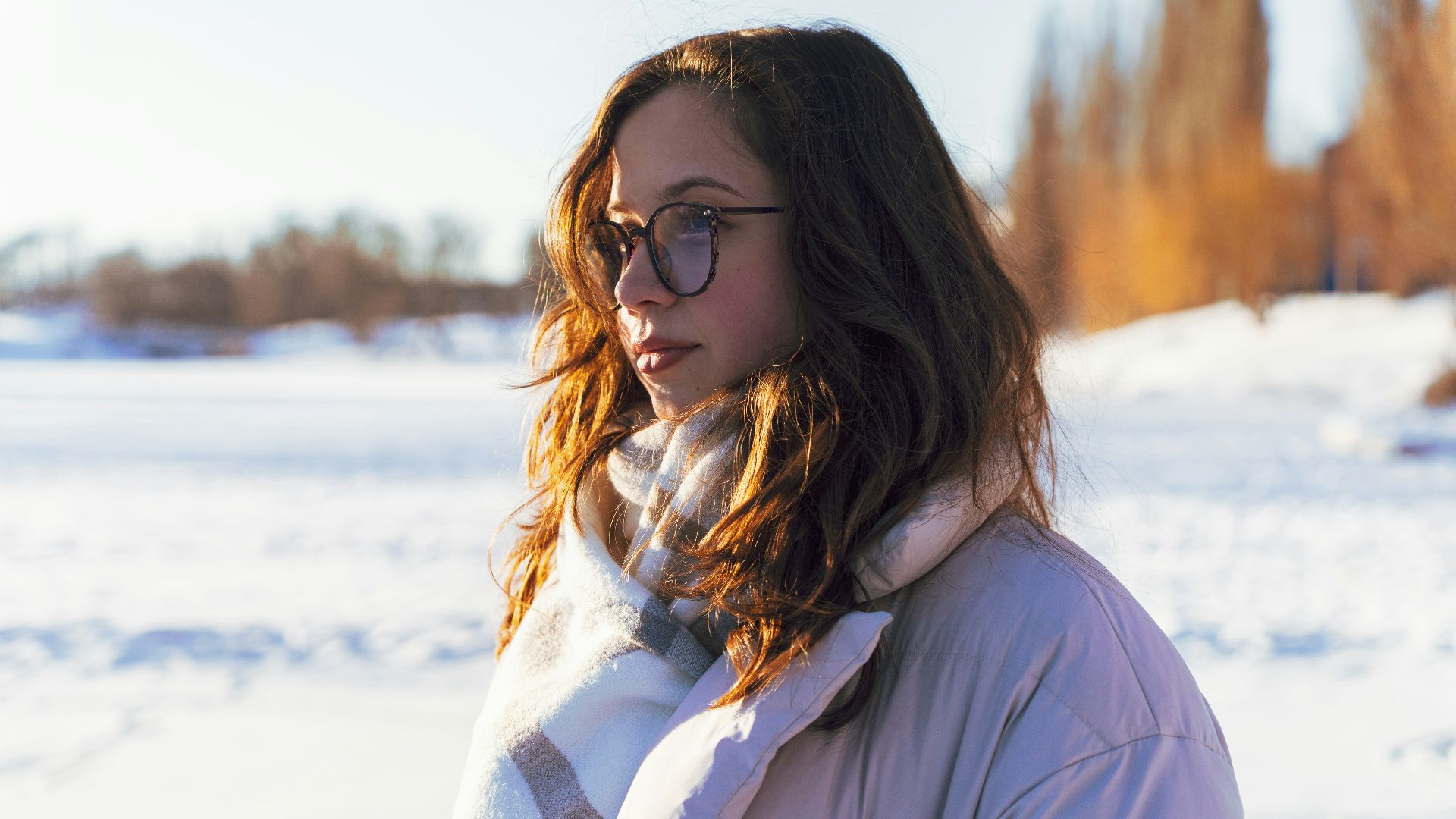 Young woman with glasses and scarf in winter