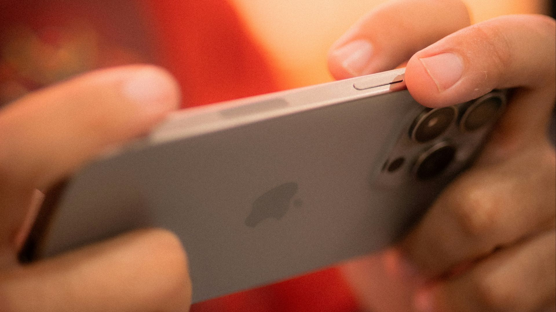 Hands holding a smartphone horizontally, playing a game.