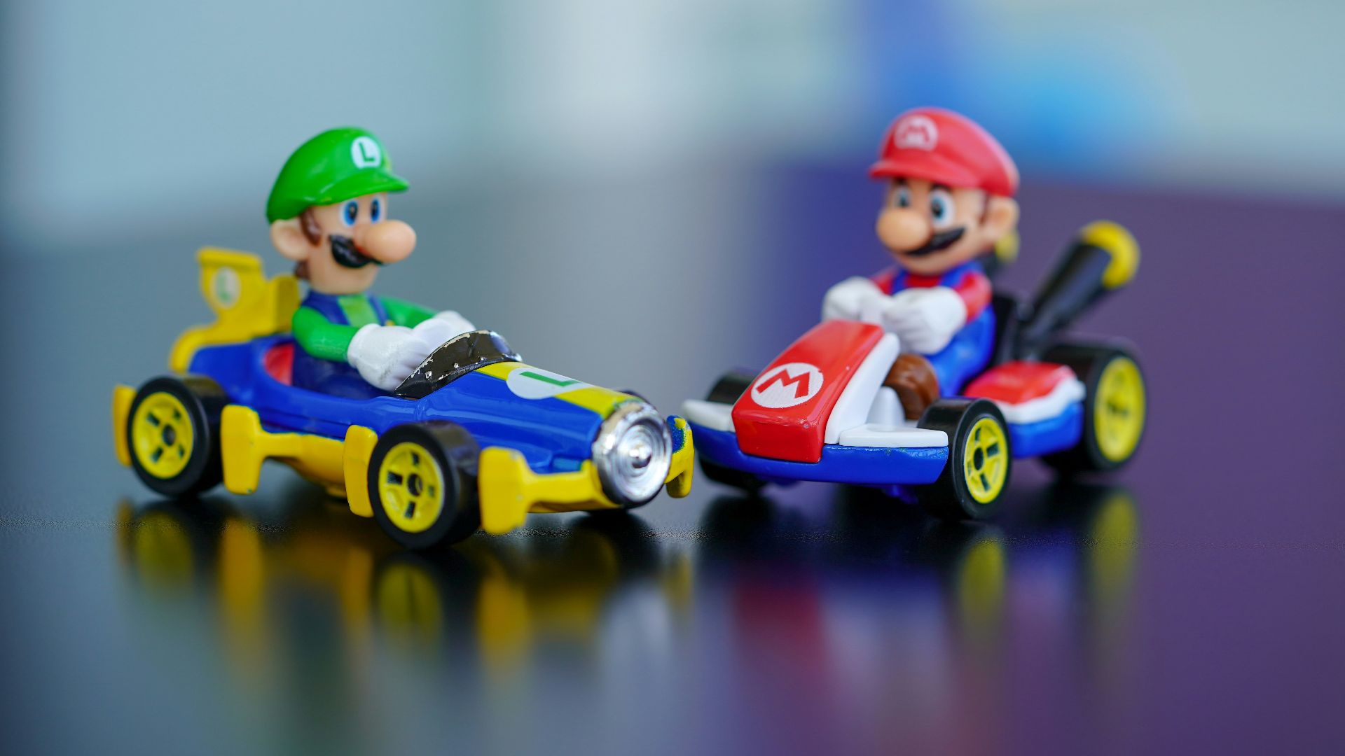 man in red helmet riding orange and blue f 1 car toy