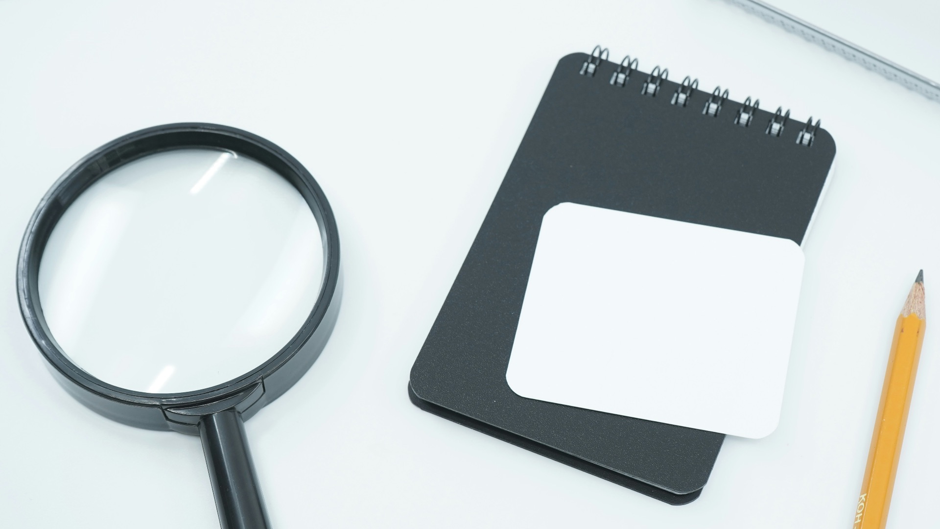 black magnifying glass on white paper