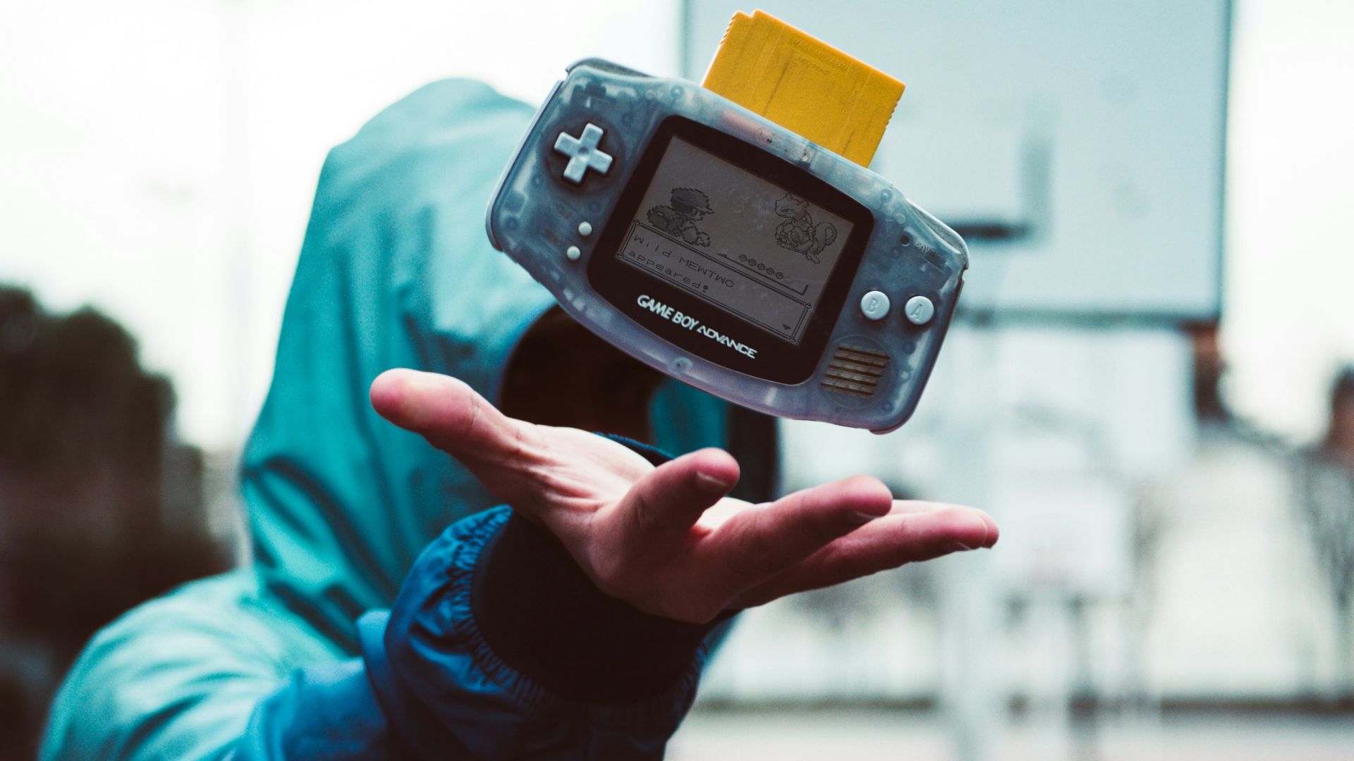 a person holding a small device in their hand