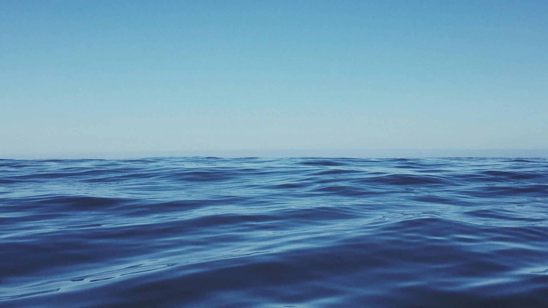 body of water under clear blue sky