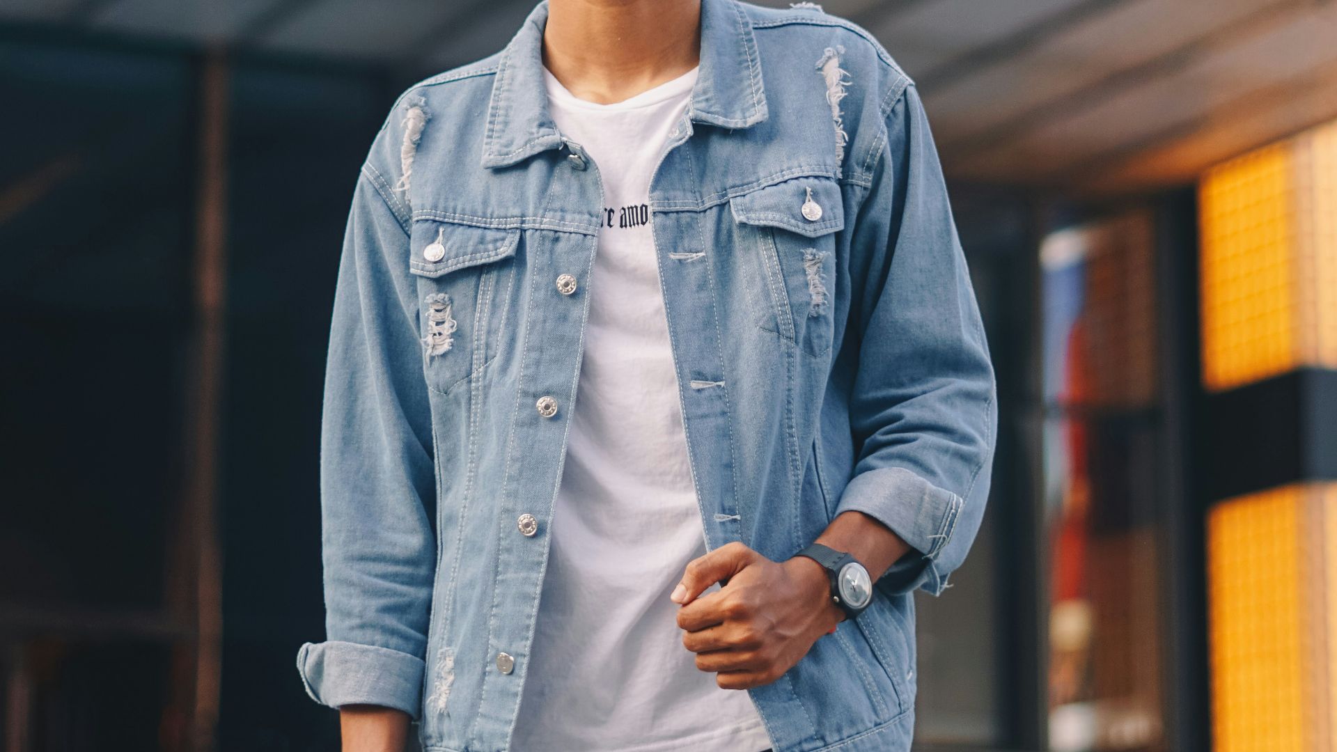 man in blue denim jacket wearing white mask
