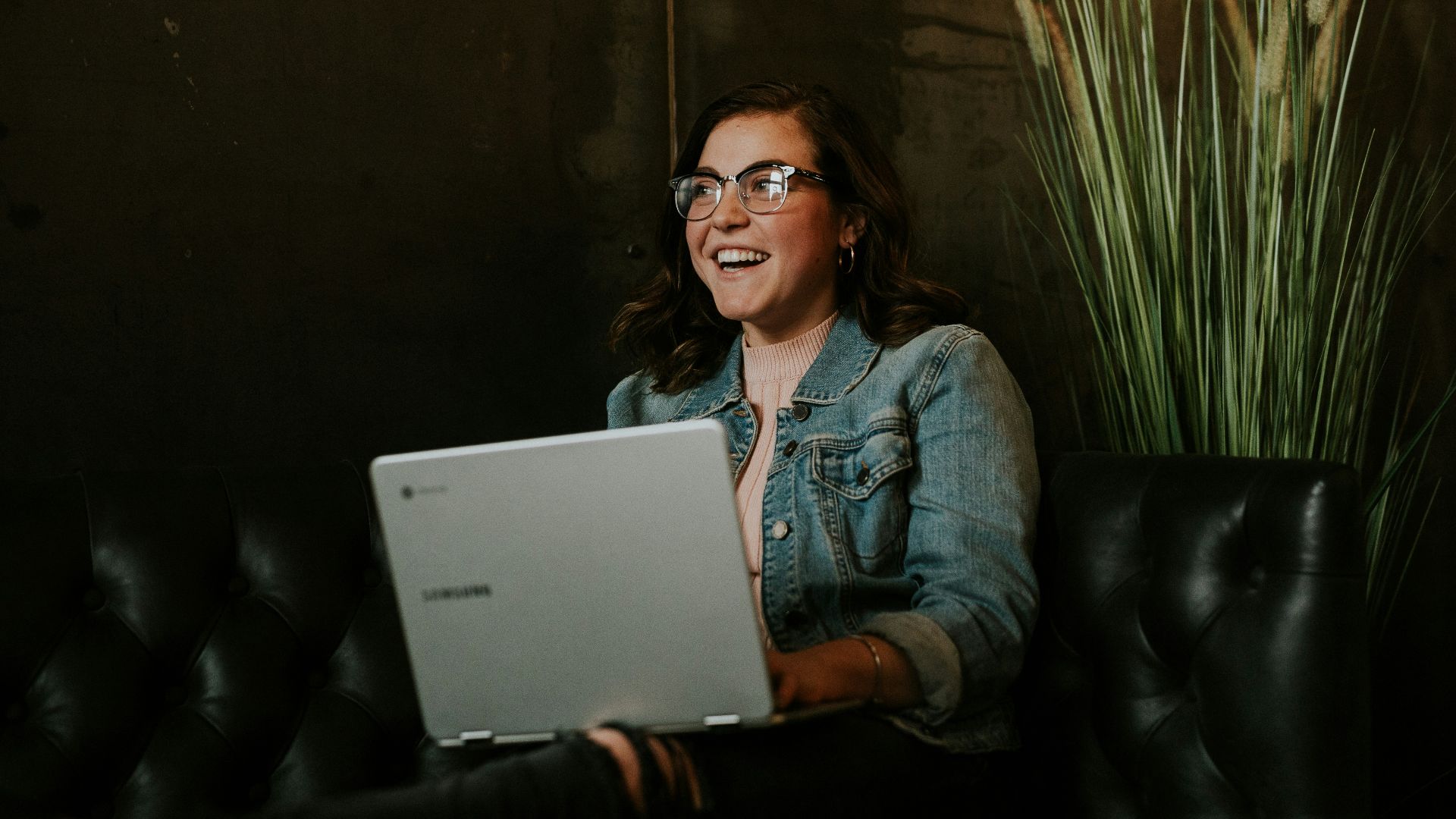 silver laptop on woman's lap