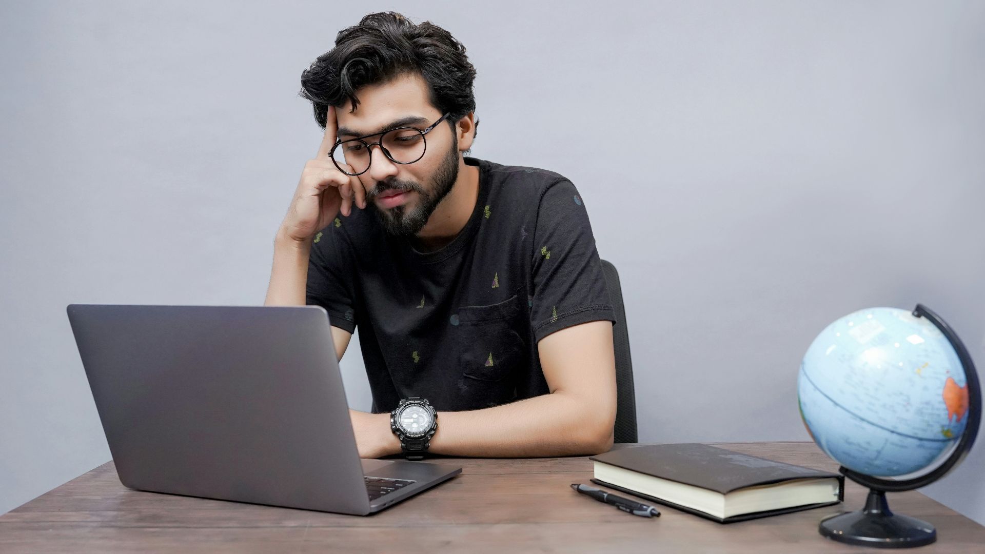 a man sitting in front of a laptop computer