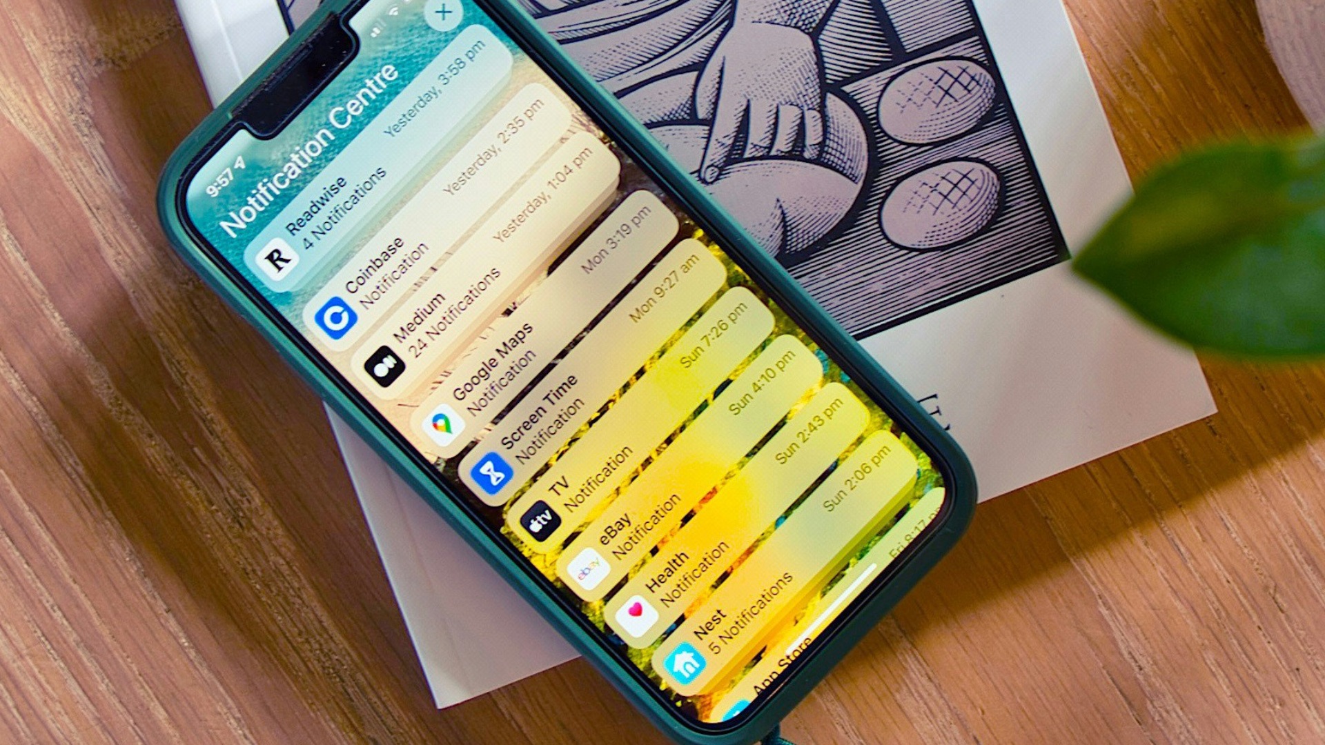 a cell phone sitting on top of a table next to a cup of coffee