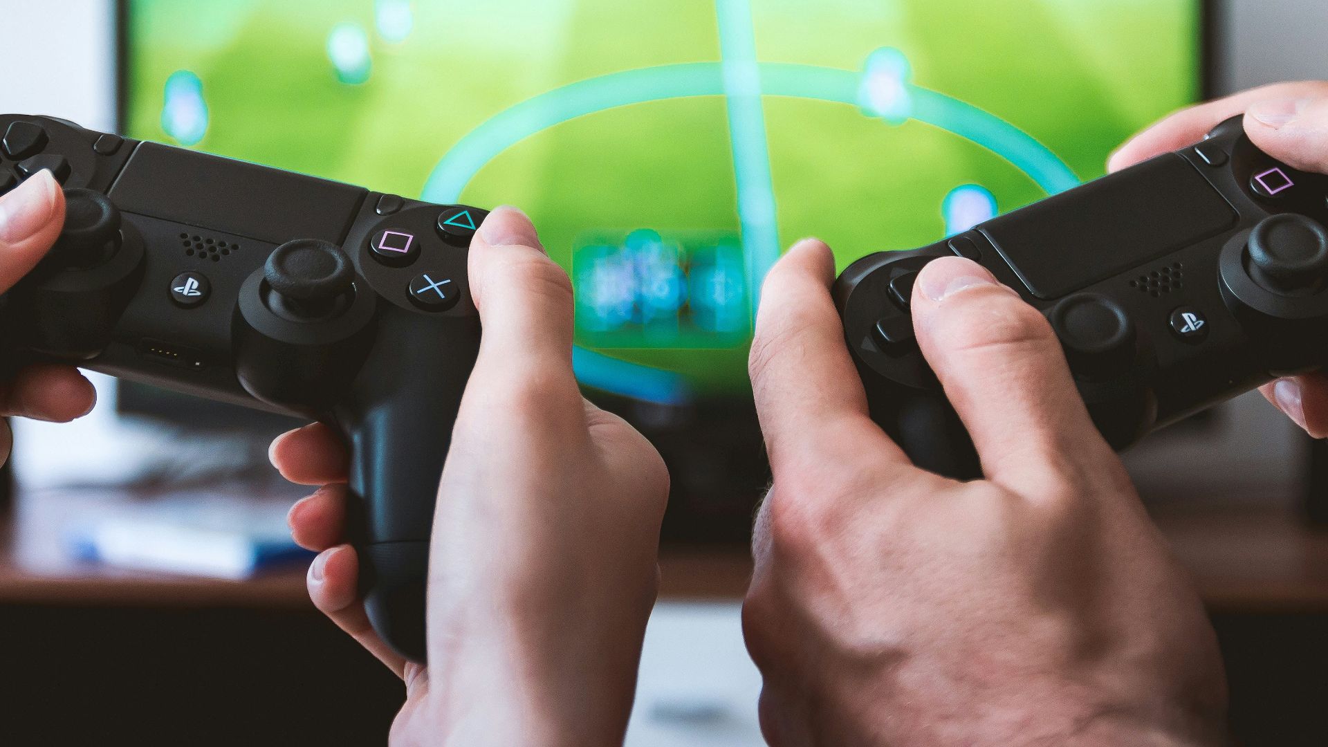 two people playing Sony PS4 game console