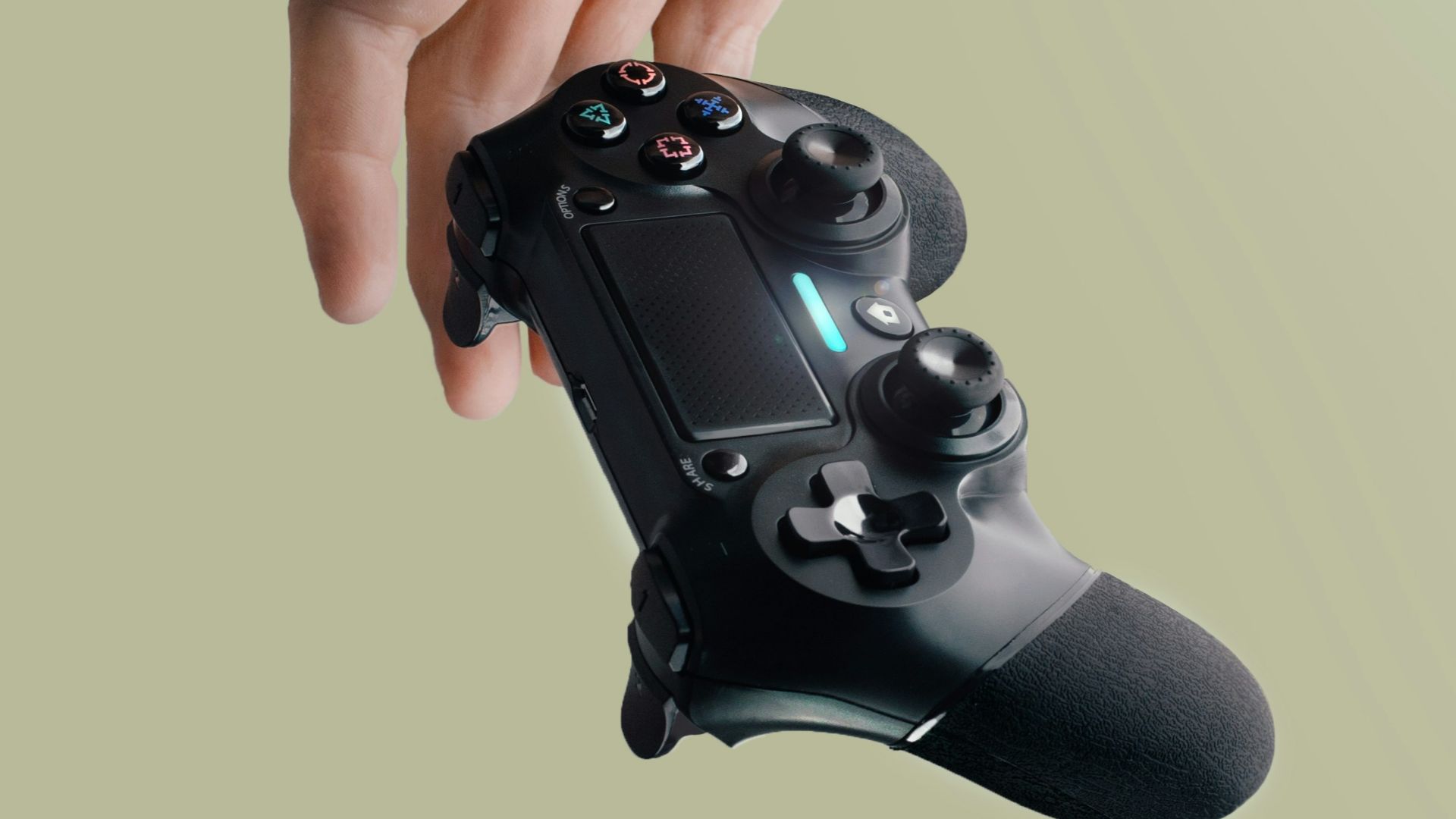 person holding Sony DualShock 4 wireless controller