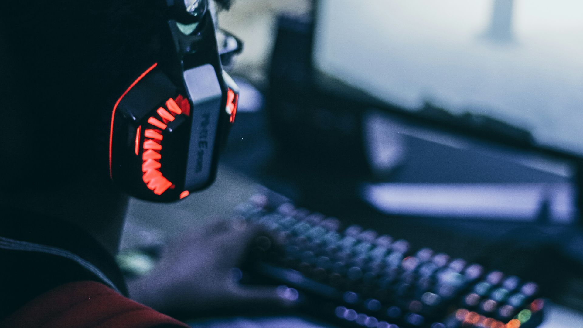 person wearing orange and black headphones