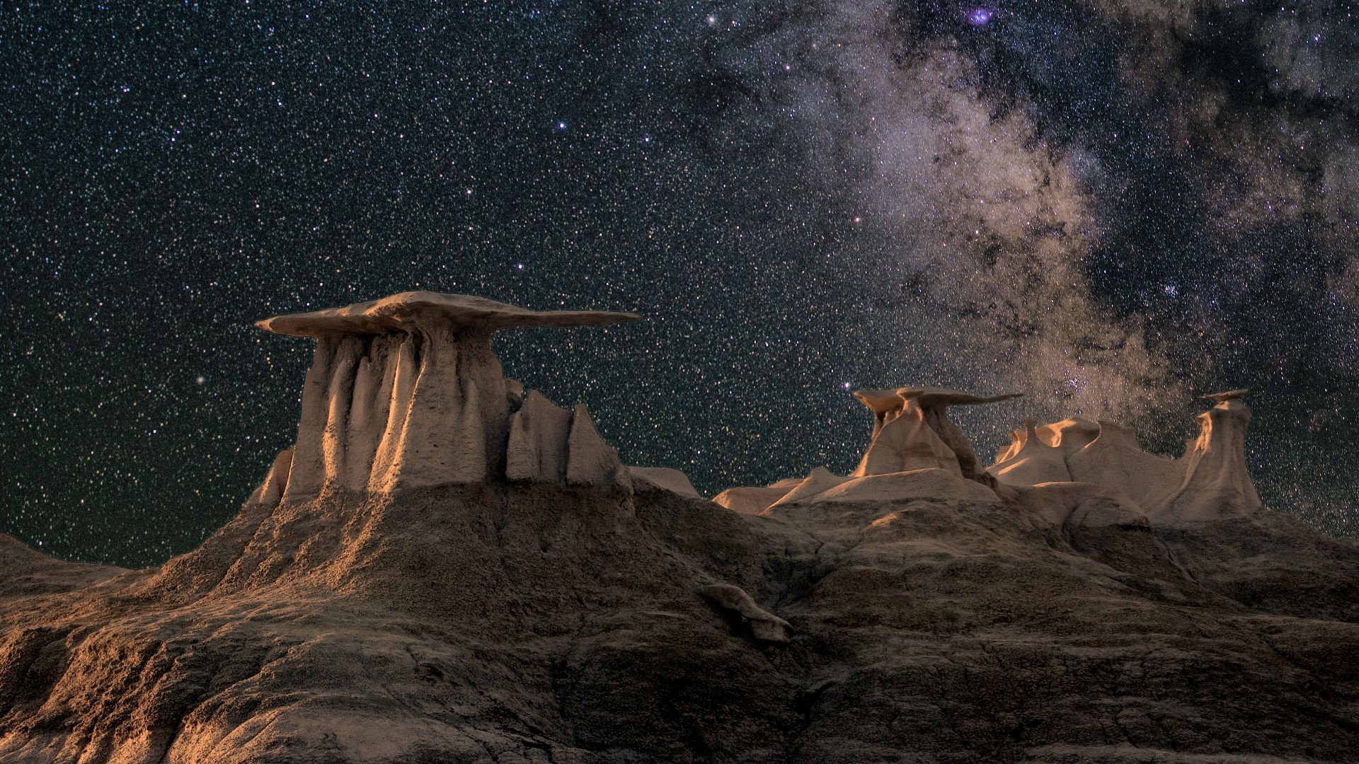 brown mountain under starry sky