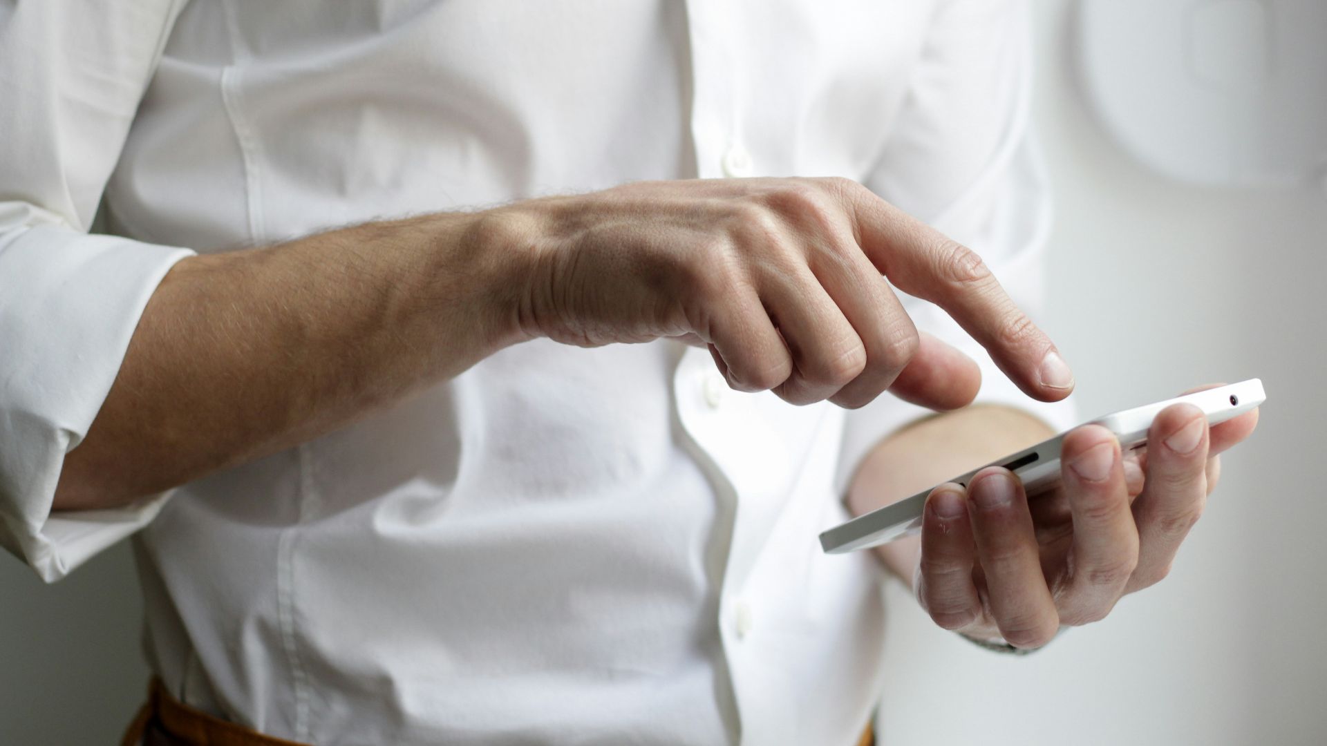 person holding white Android smartphone in white shirt