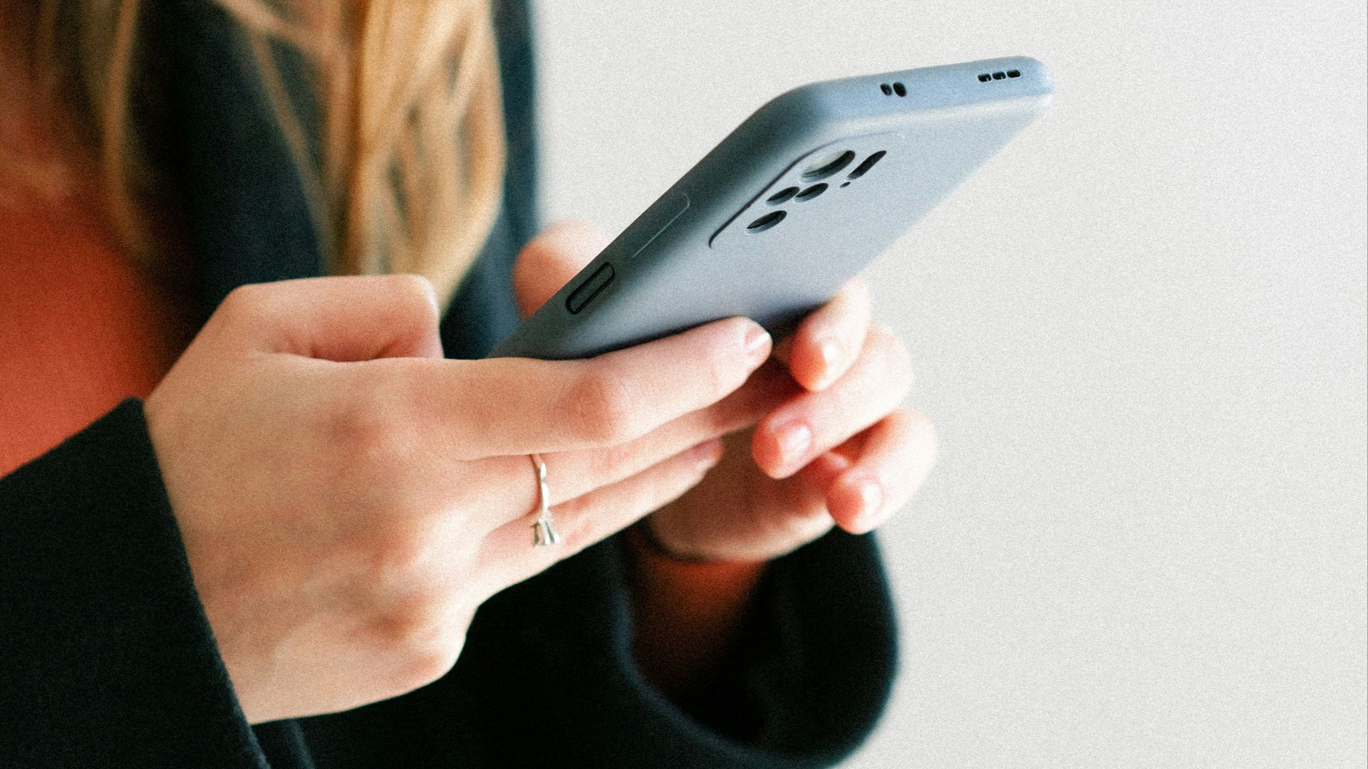a woman holding a cell phone in her hands