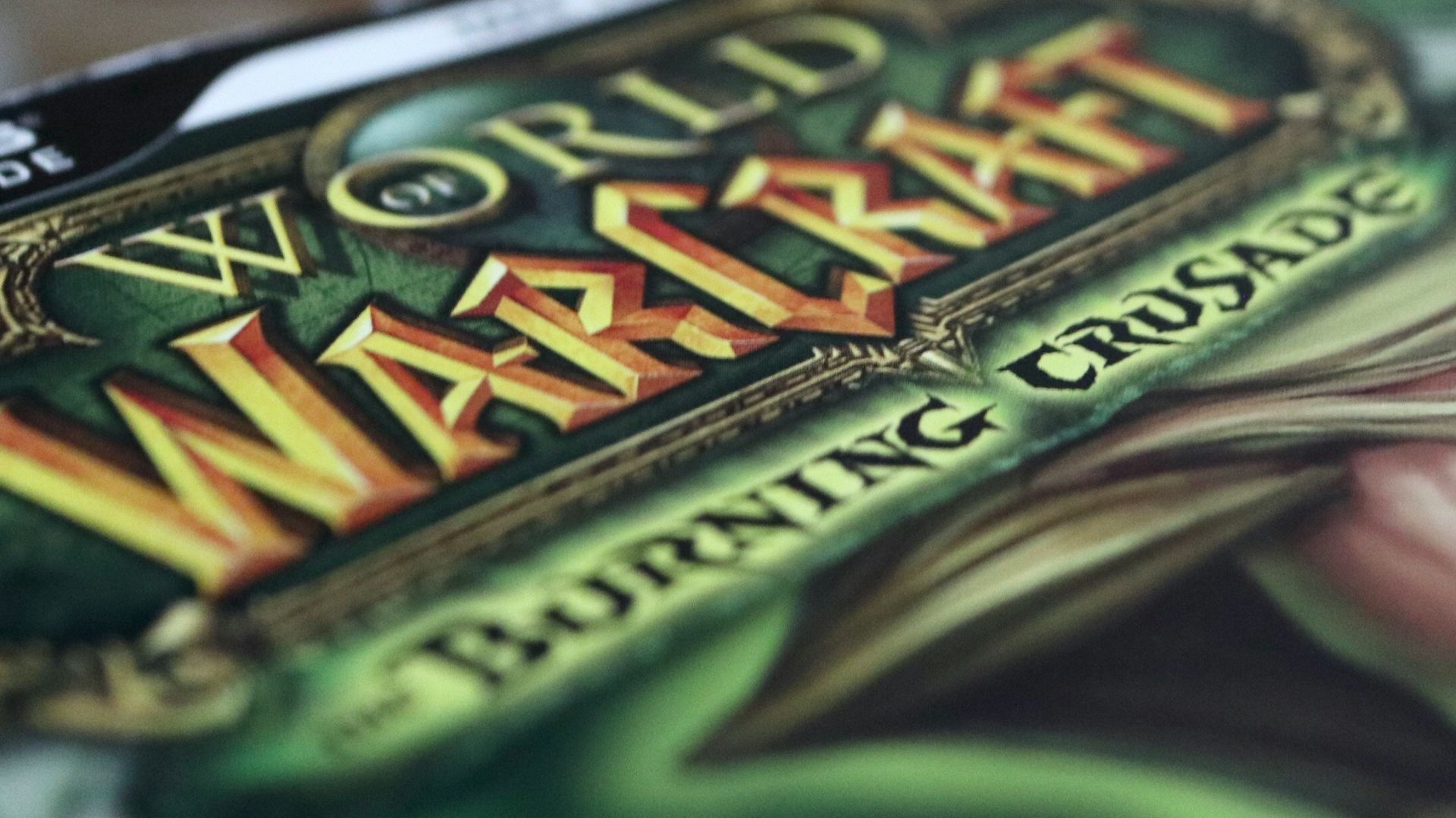 brown tabby cat on green and white textile