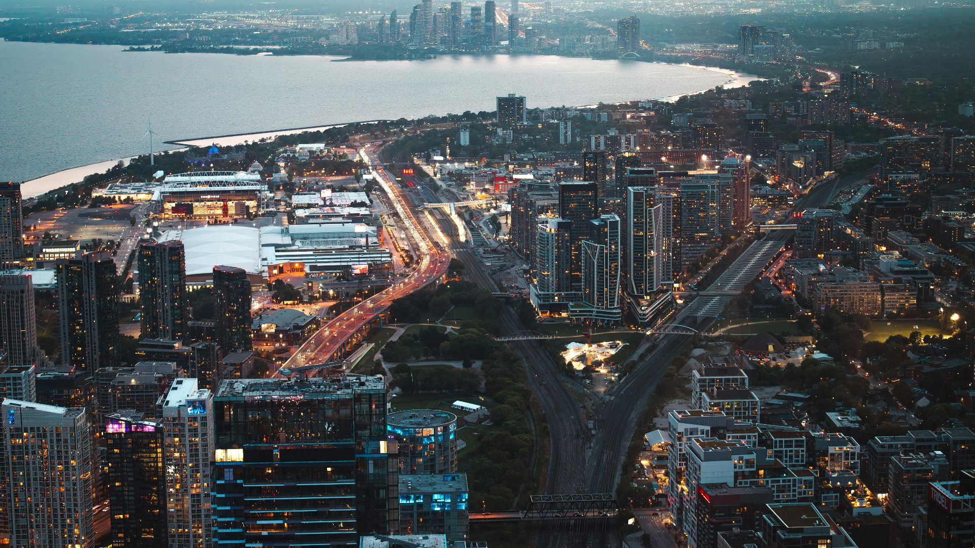 Aerial view of a city skyline at dusk with lights.