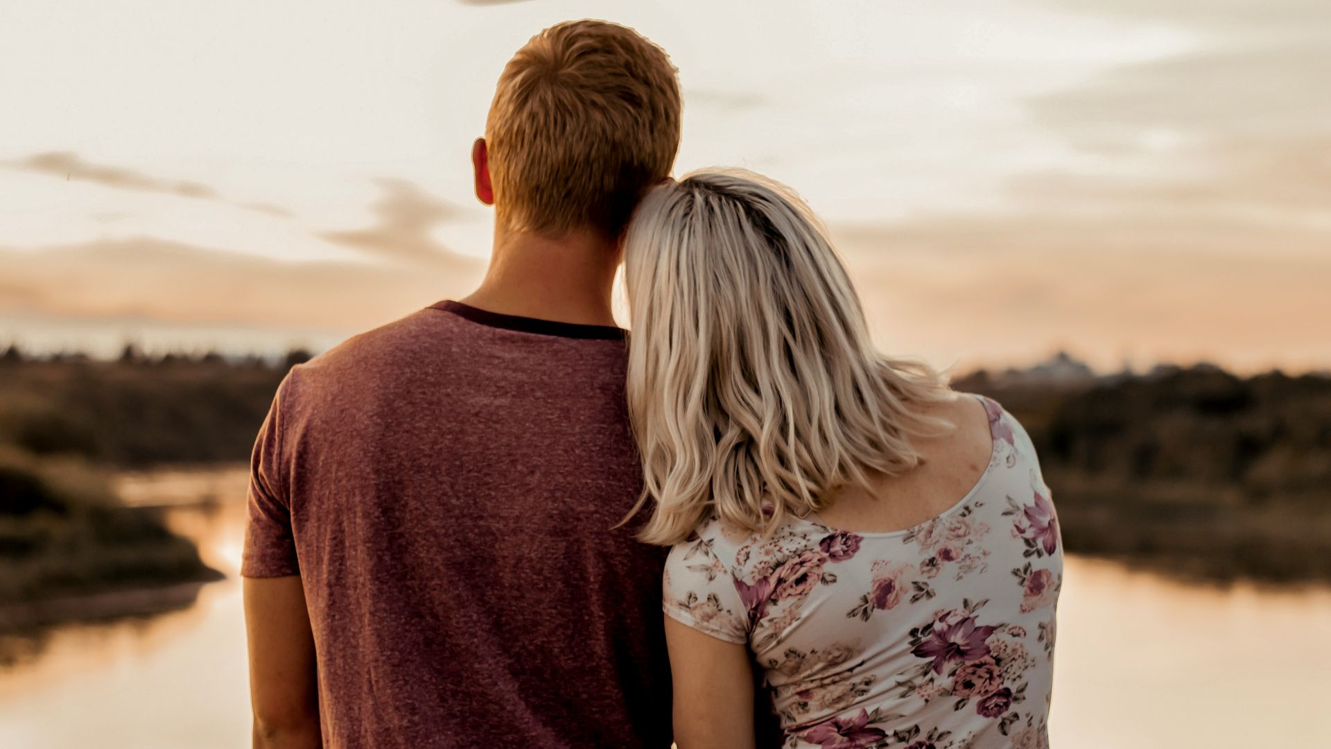 man and woman standing on brown field during daytime