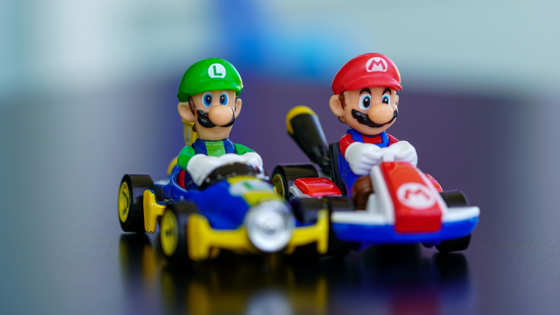 lego mini figure riding blue and red toy car