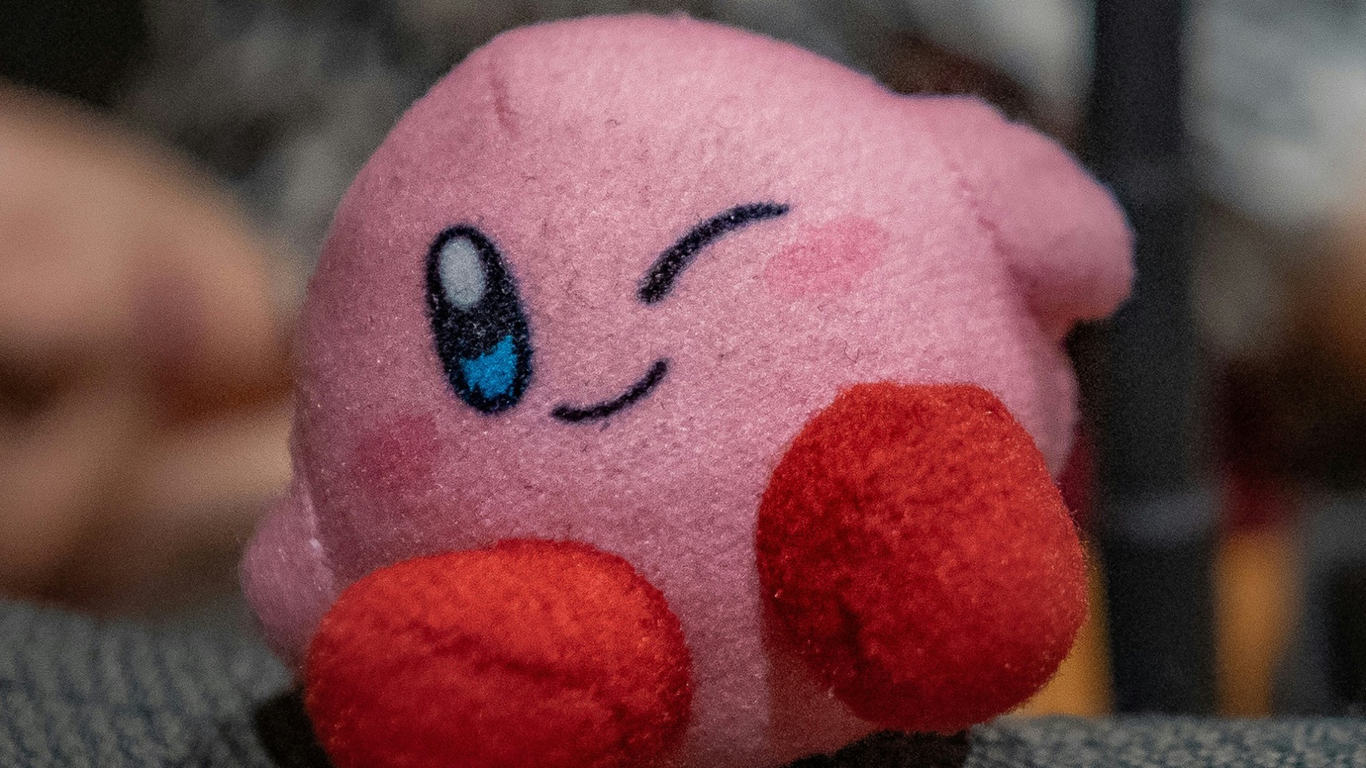 a pink stuffed animal laying on top of a couch