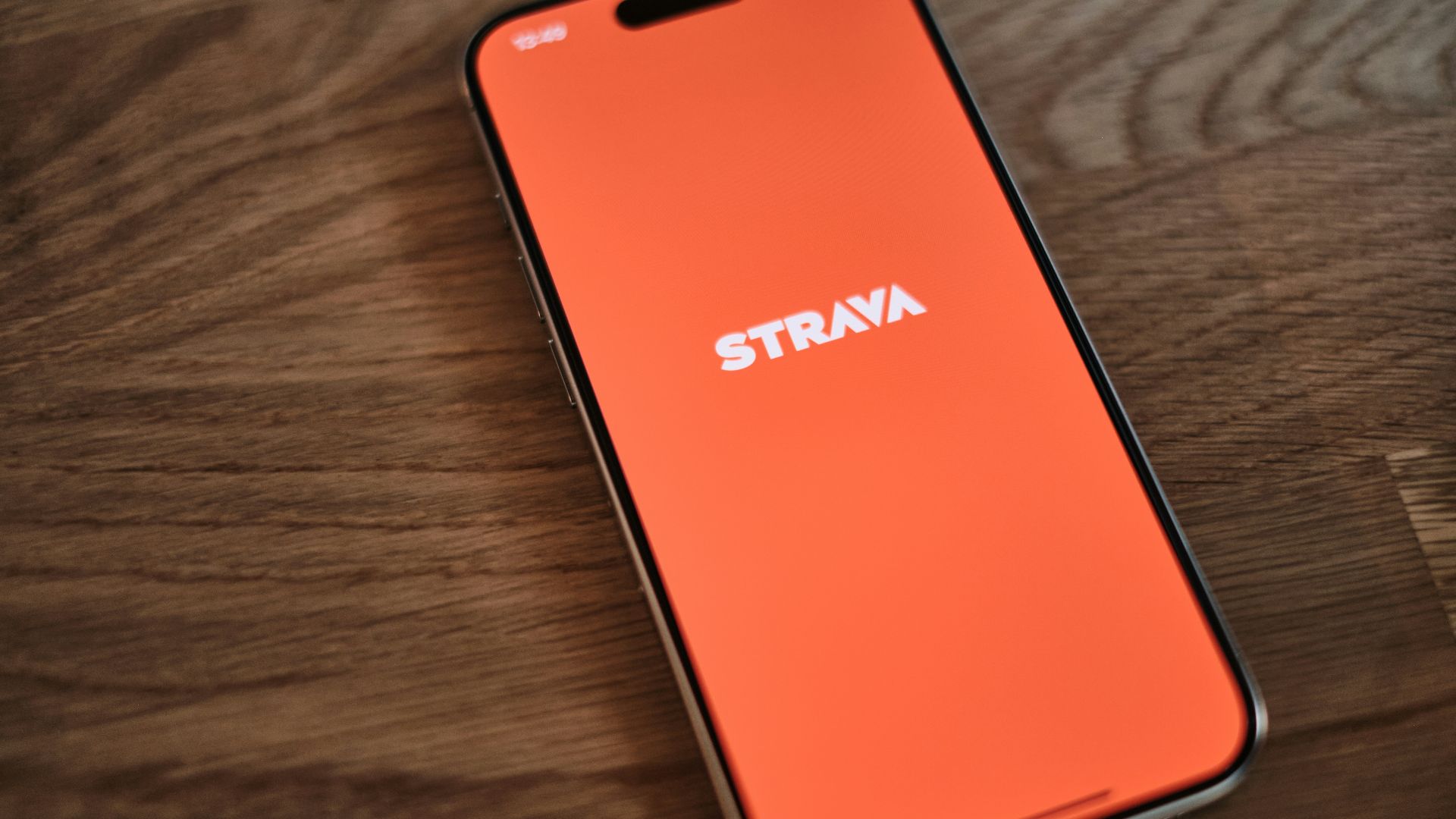 A cell phone sitting on top of a wooden table