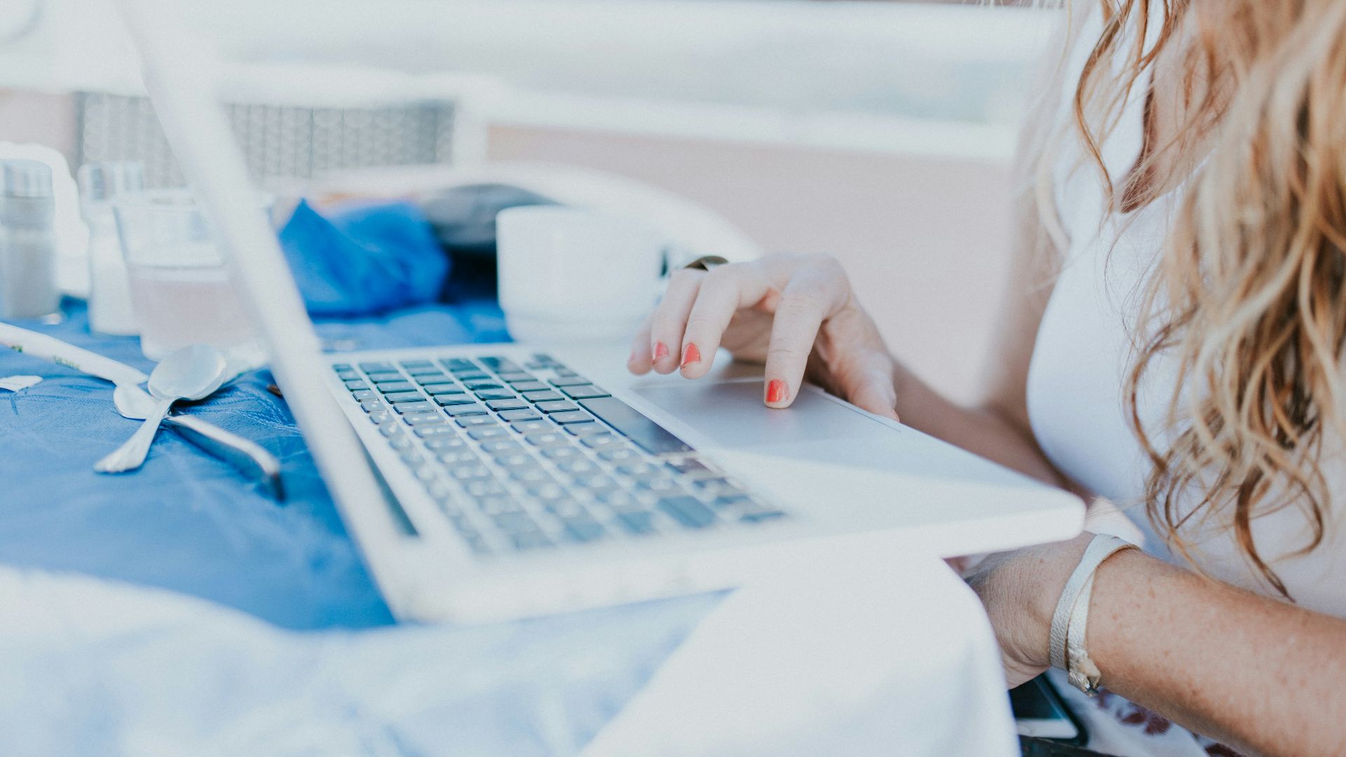 woman sitting near table using laptop computer