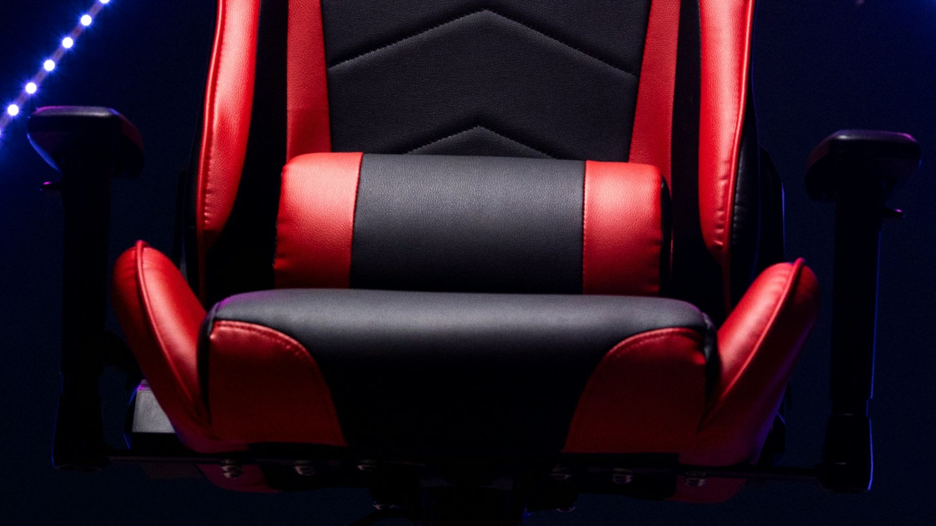 A red and black gaming chair with neon lights