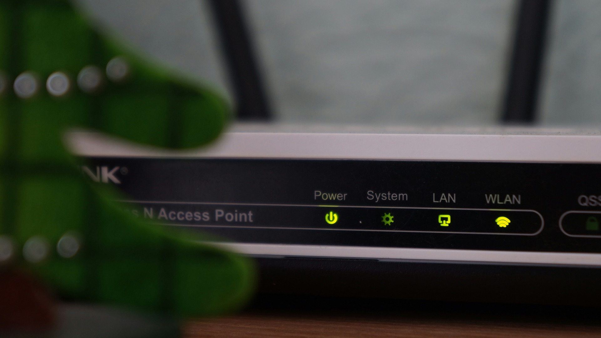 white and black modem router with four lights