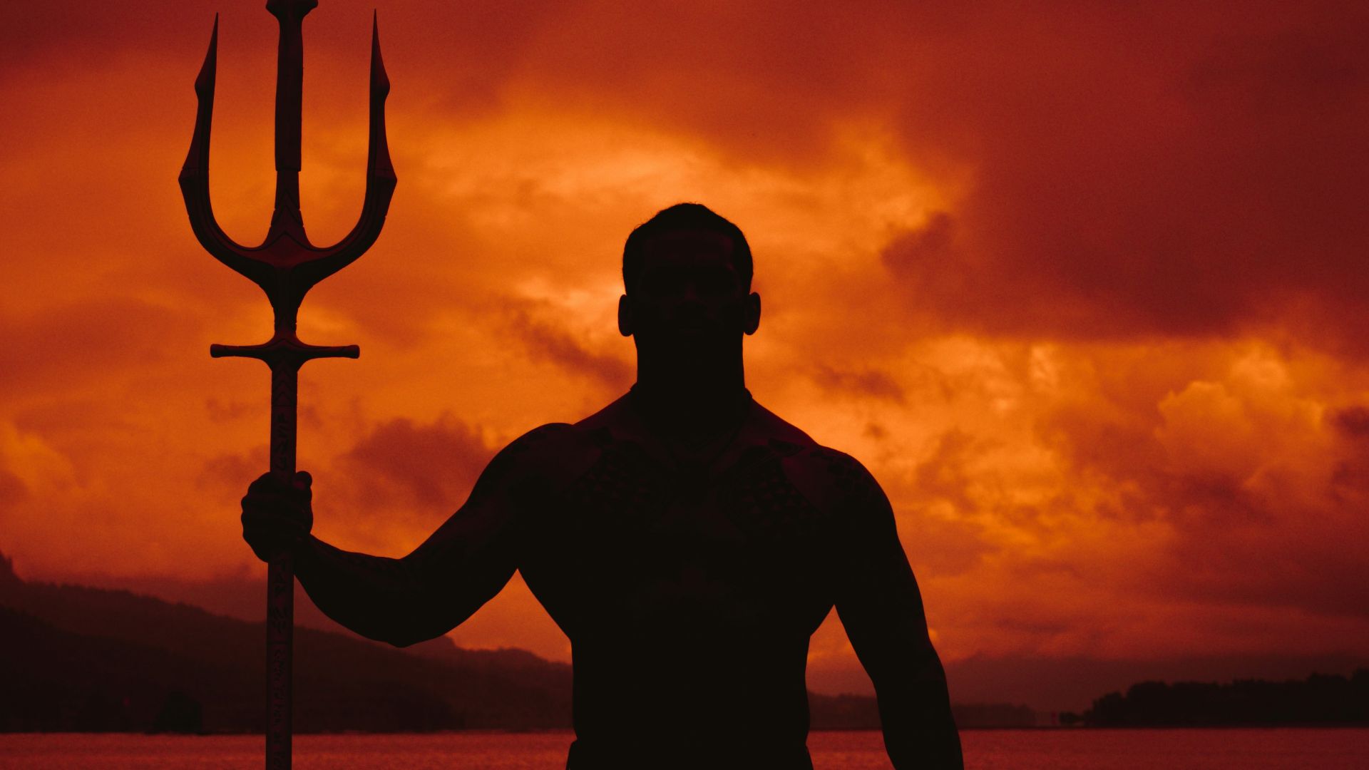 a man standing in the water with a pole in his hand