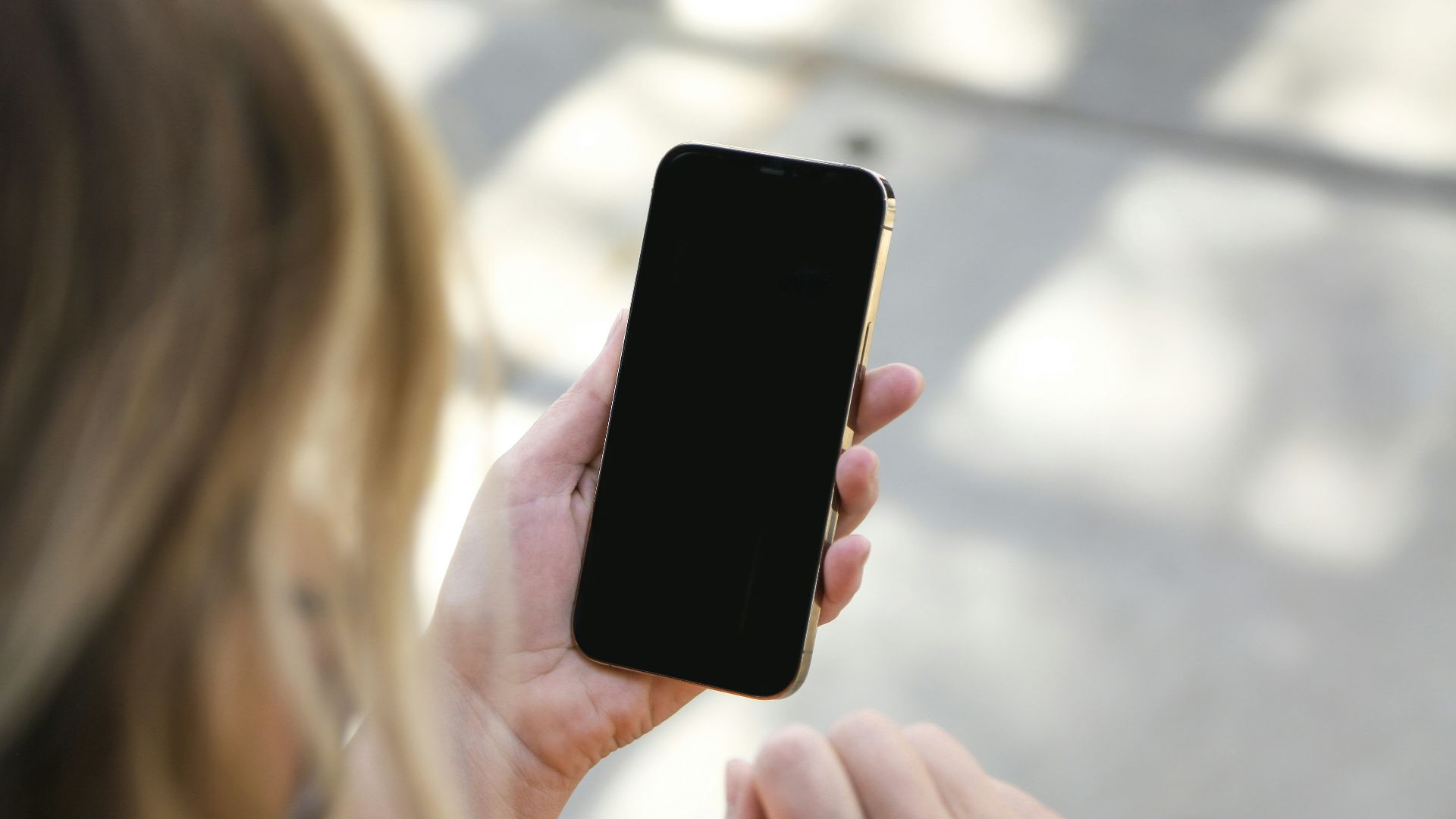 woman holding black iphone 5