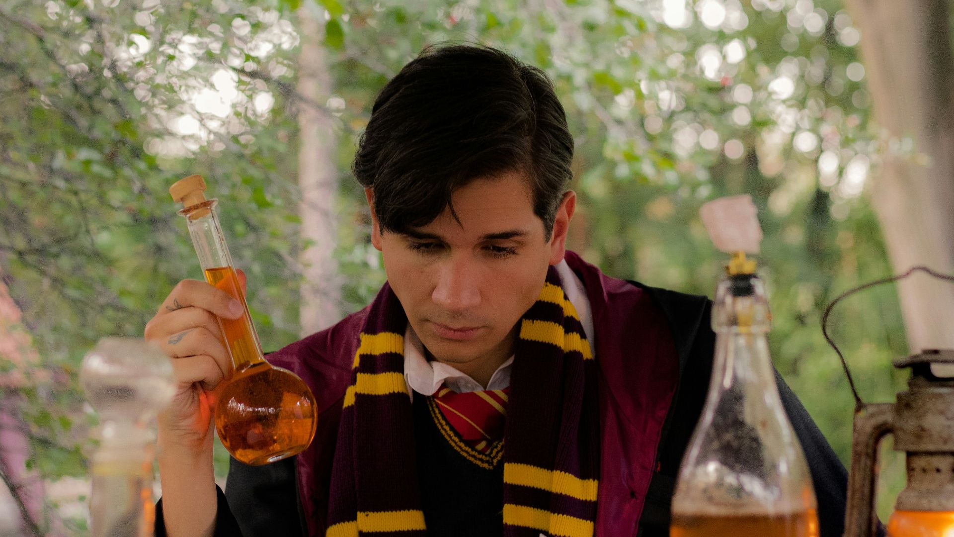 a person sitting at a table with a book and a bottle