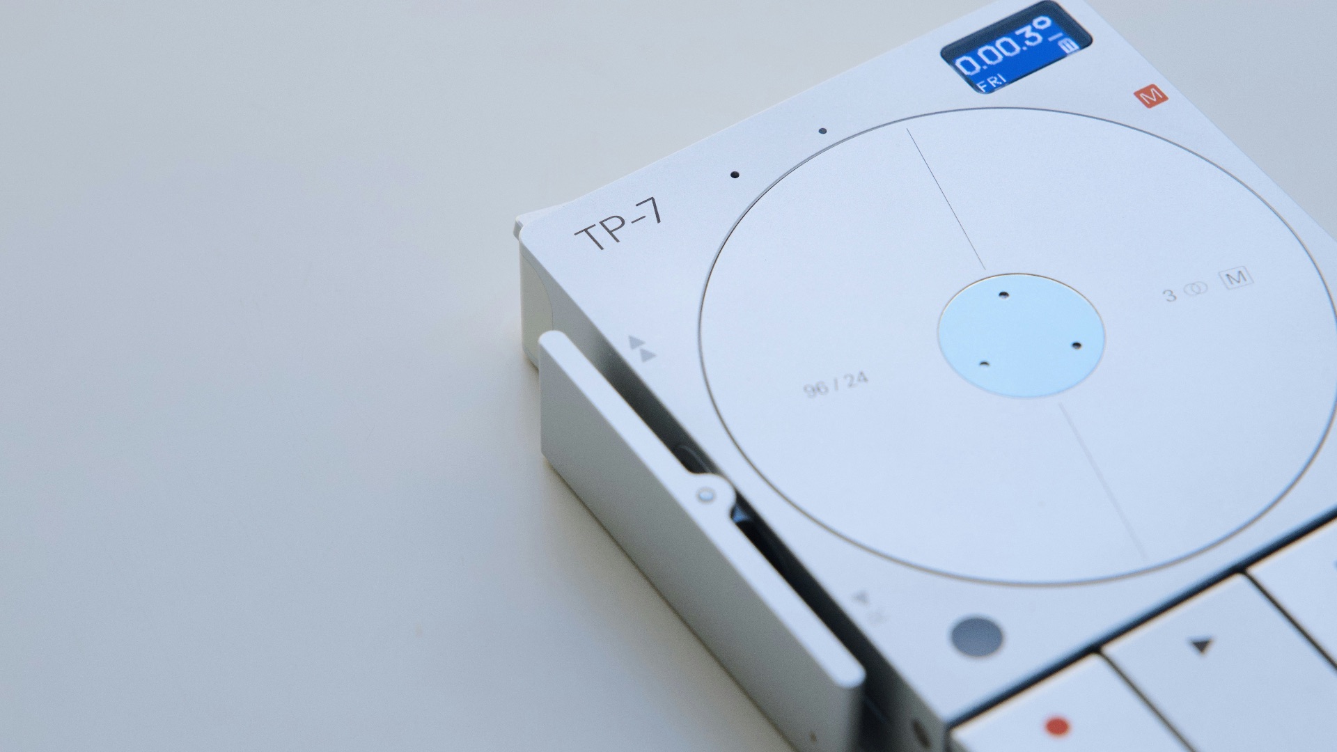 a white cd player sitting on top of a table