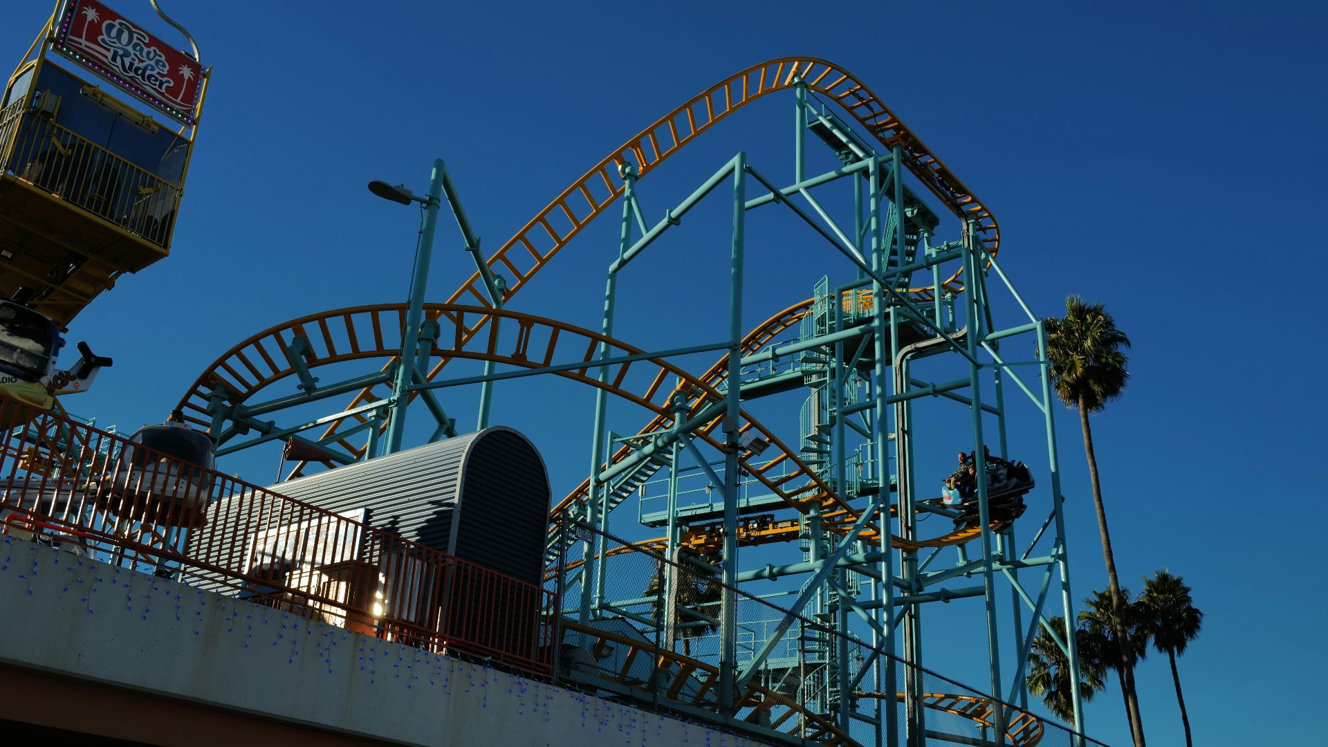 Roller coaster against a clear blue sky.