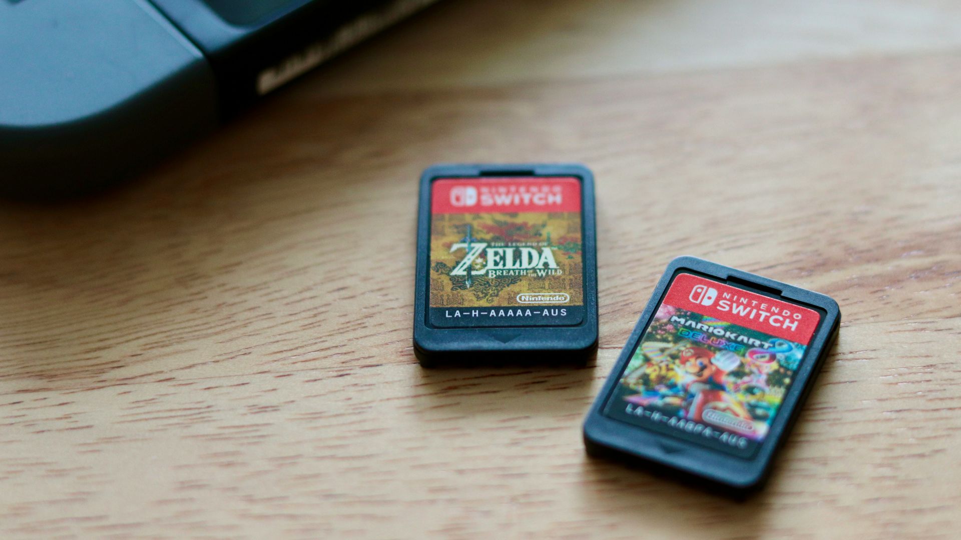 a couple of nintendo games sitting on top of a wooden table