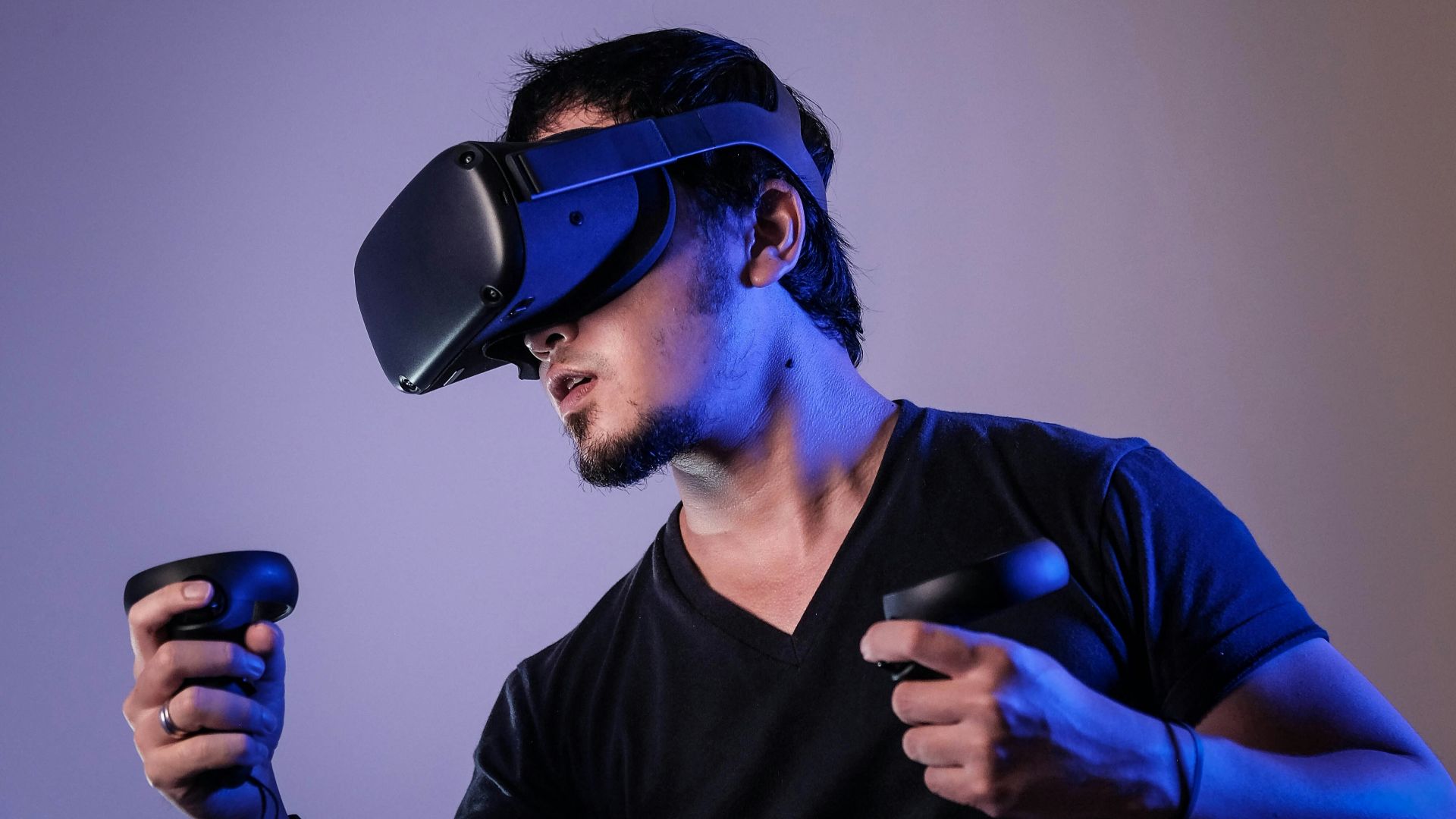 man in black crew neck t-shirt wearing black sunglasses holding black smartphone