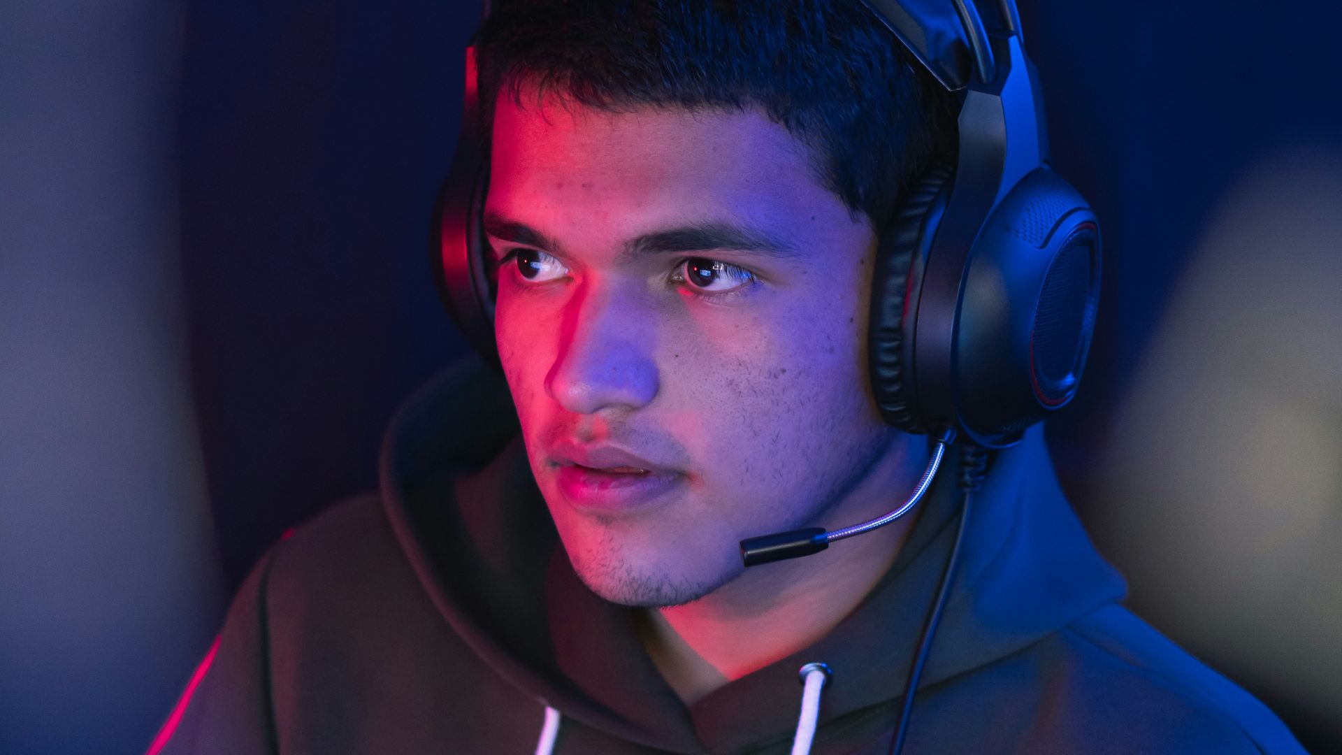 man in blue hoodie wearing black headphones